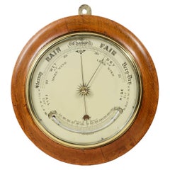 Aneroid barometer and thermometer in Fahrenheit scale in late 19th century oak wood