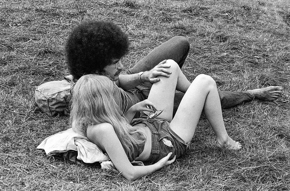Baron Wolman Black and White Photograph - Woodstock 1969, Couple in the Grass