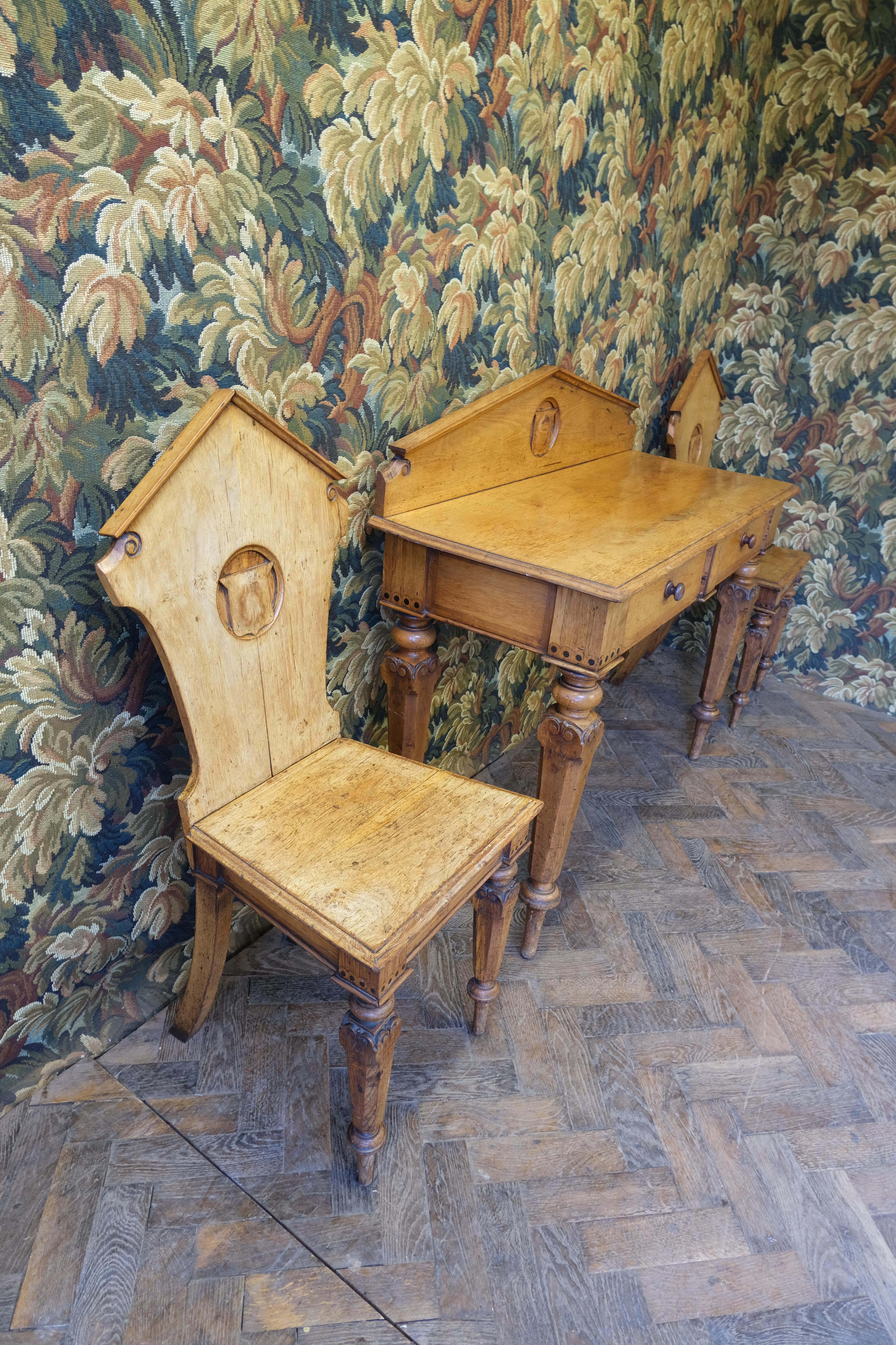 Discover an exceptional piece of Scottish heritage with our solid oak 19th-century Scottish Baronial hall suite, now available at Hutton-Clarke Antiques. This rare ensemble includes a pair of hall chairs and a matching table, each adorned with