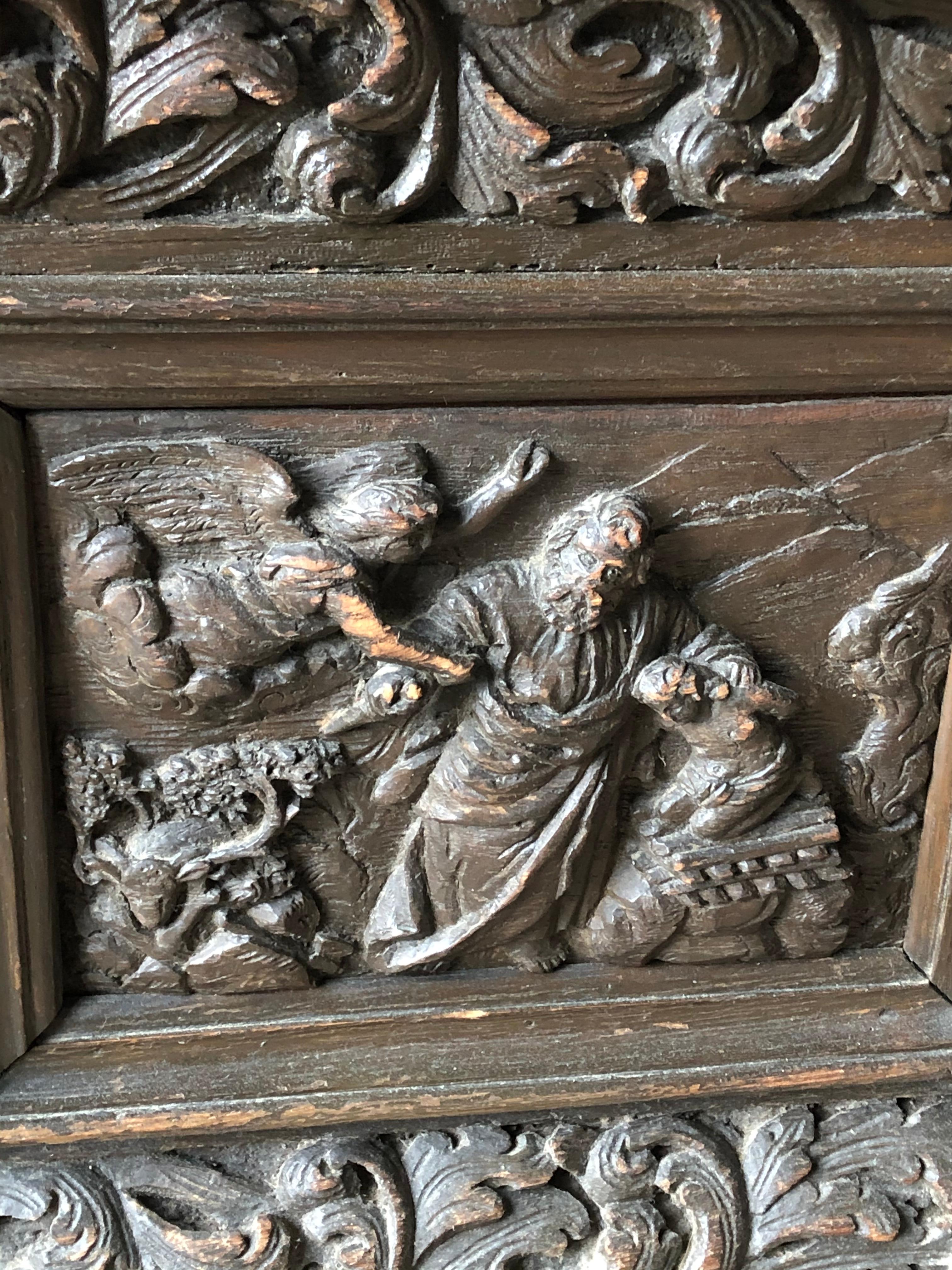 An 18th century Flemish chest with lid, in dark stained oak, elaborately carved with Biblical scenes (Lot feeing Sodom and Gomorrah, Angel staying the hand of Abraham’s sacrifice.). The box retains its original iron lock and key.