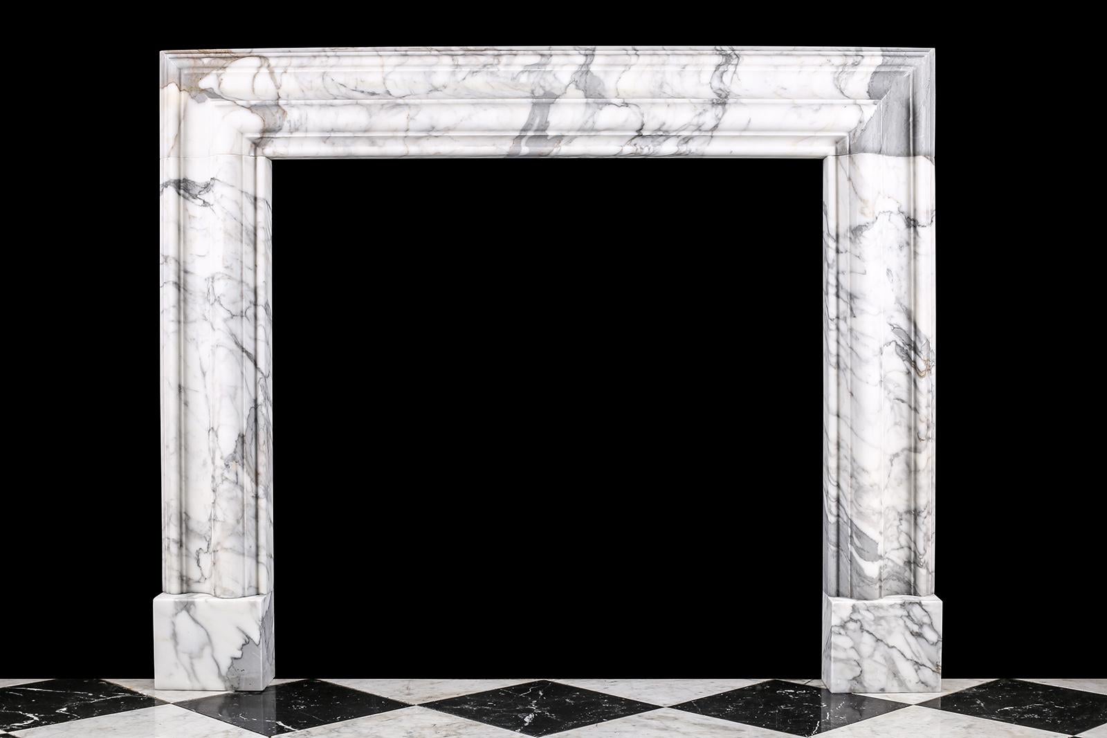 Baroque Bolection Chimneypiece in Italian white statuary marble fireplace

A Baroque style Bolection fireplace surround of bold proportions with very finely carved columns with a rising ogee edging, which are supported on substantial footblocks,