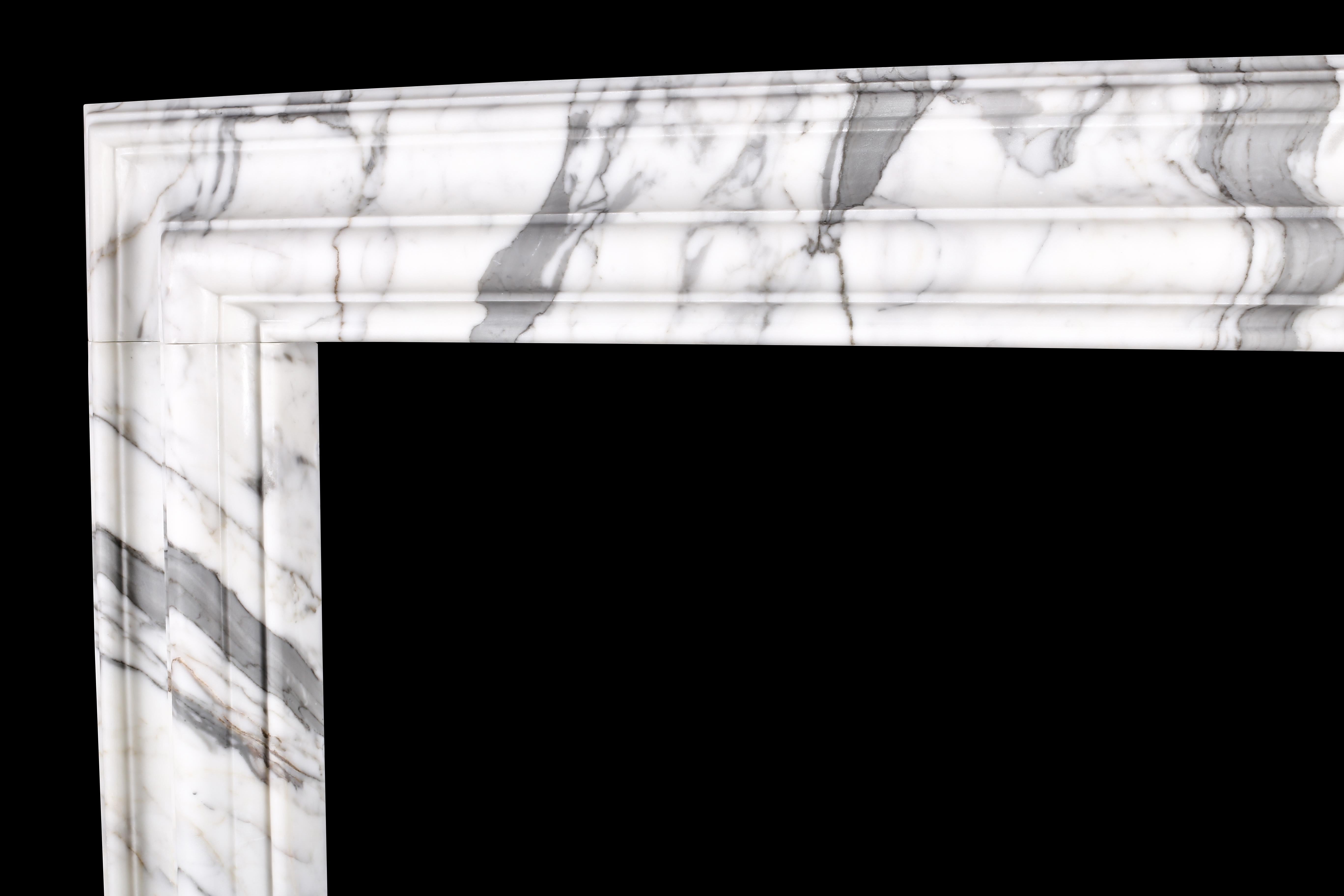 A baroque bolection fireplace mantel (fireplace) in Italian white statuary marble 5.

A Baroque style bolection fireplace surround of bold proportions with very finely carved columns with a rising ogee edging, which are supported on substantial