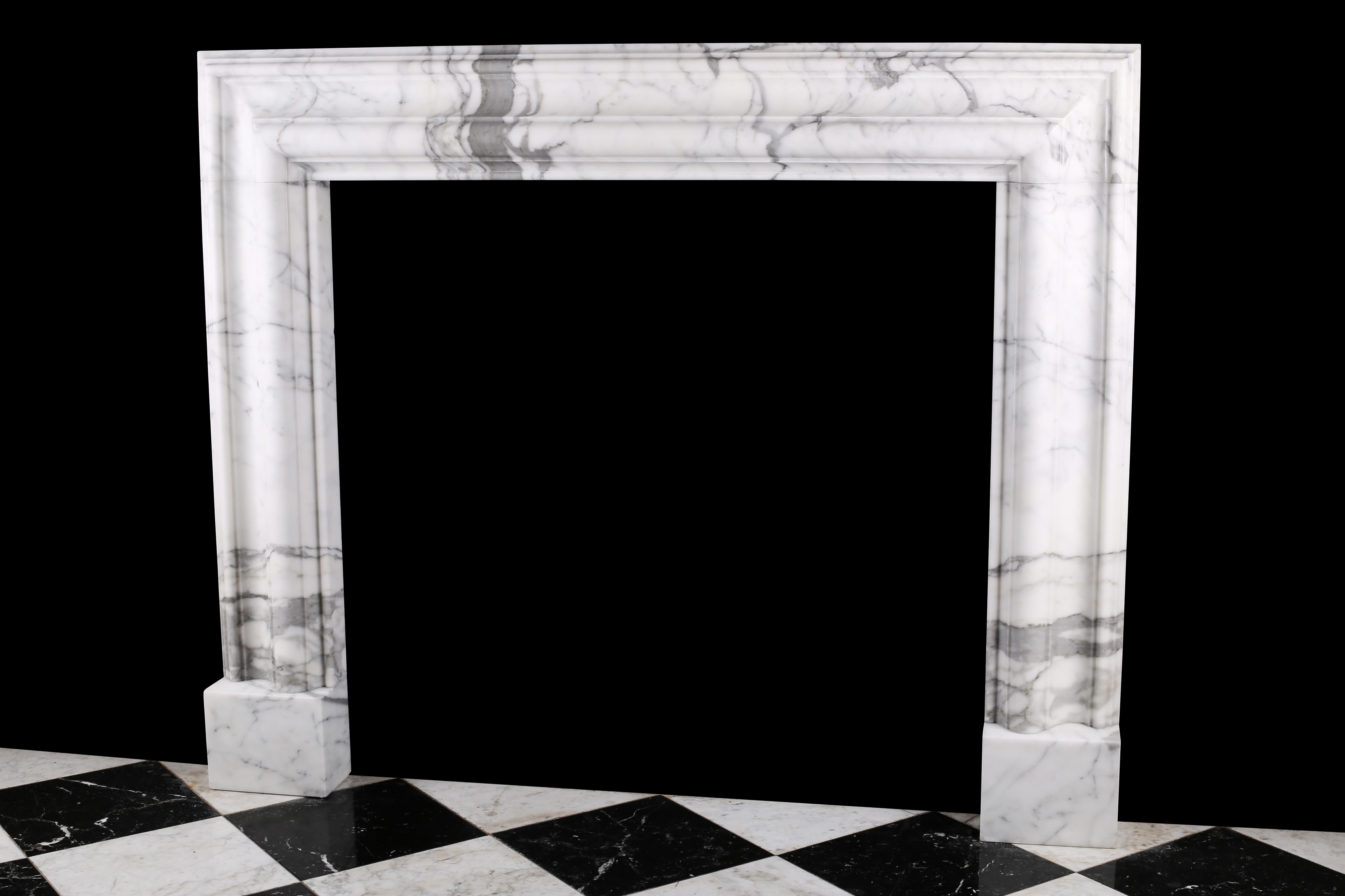 A Baroque Bolection fireplace surround in Italian white statuary marble fireplace 2.

A Baroque style Bolection fireplace surround of bold proportions with very finely carved columns with a rising ogee edging, which are supported on substantial