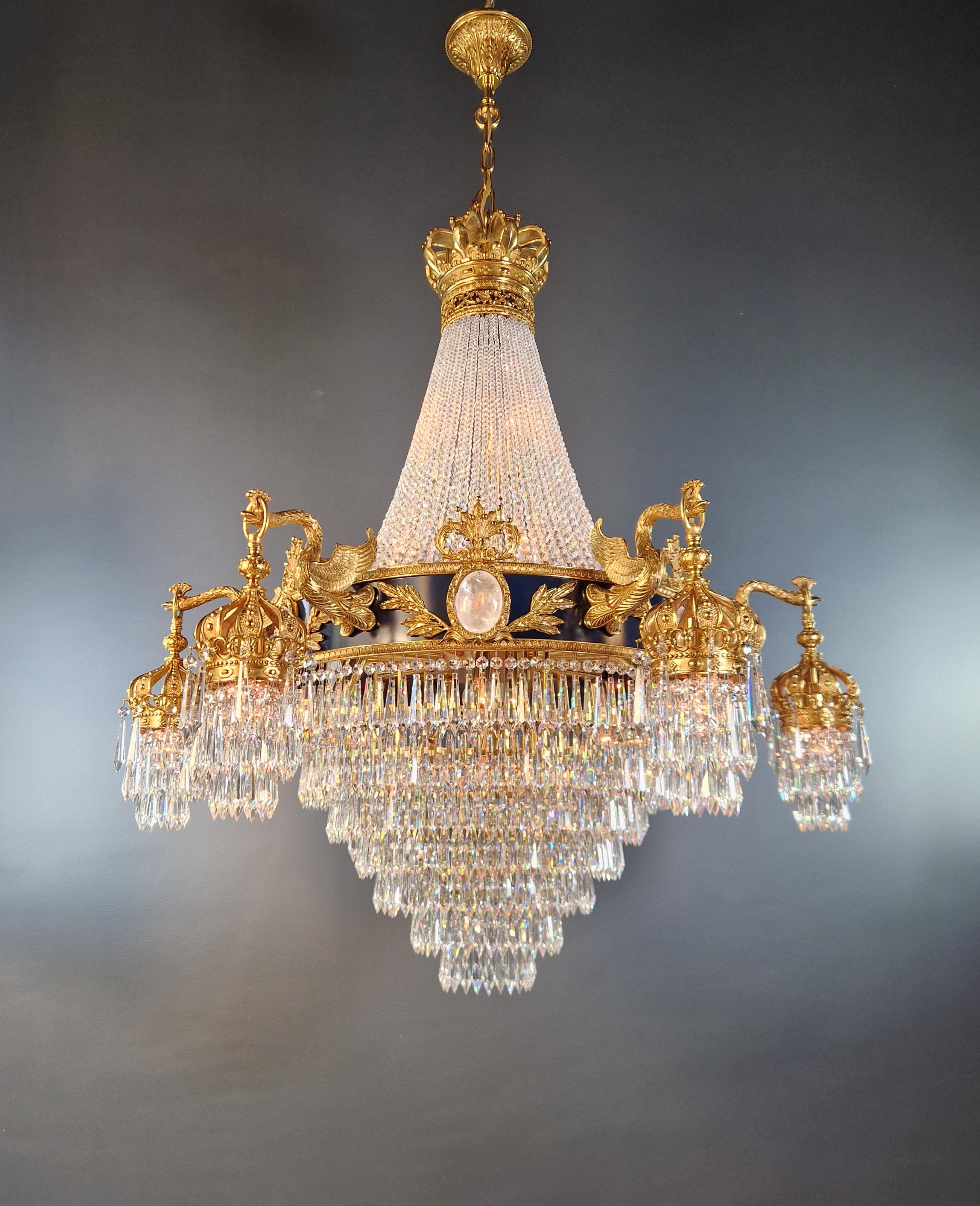 Introducing a stunning Brass Baroque Empire Chandelier, an exquisite piece adorned with captivating crystals, reminiscent of the classical style of the Empire era. This is a new reproduction, and several are available, ensuring you can bring this