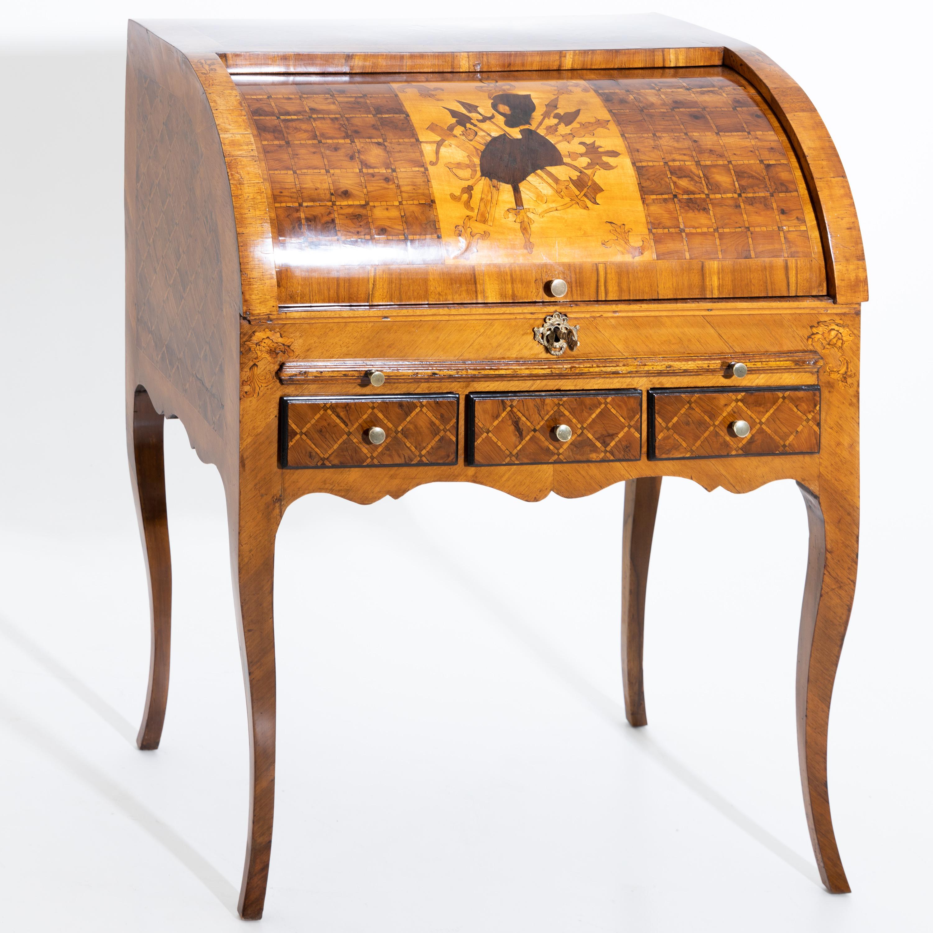 Small bureau on elegantly curved high legs with curved frame. The front is divided by three drawers, a pull-out writing desk and the quarter-cylinder-shaped roll-up flap. Large Marquetry work in the form of military equipment on the front. The