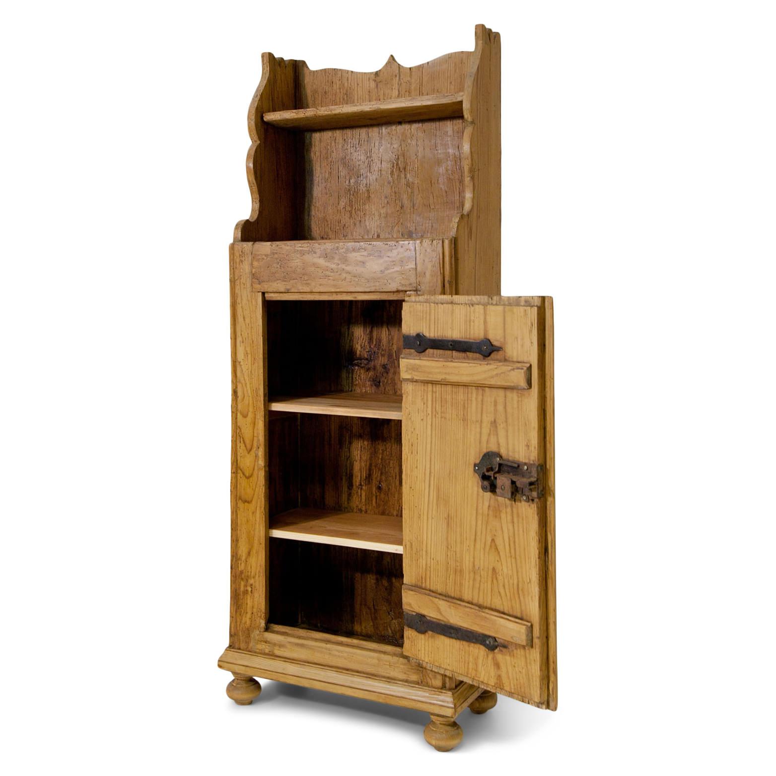 One-doored cabinet out of softwood with one shelf on top and a very nice iron lock.