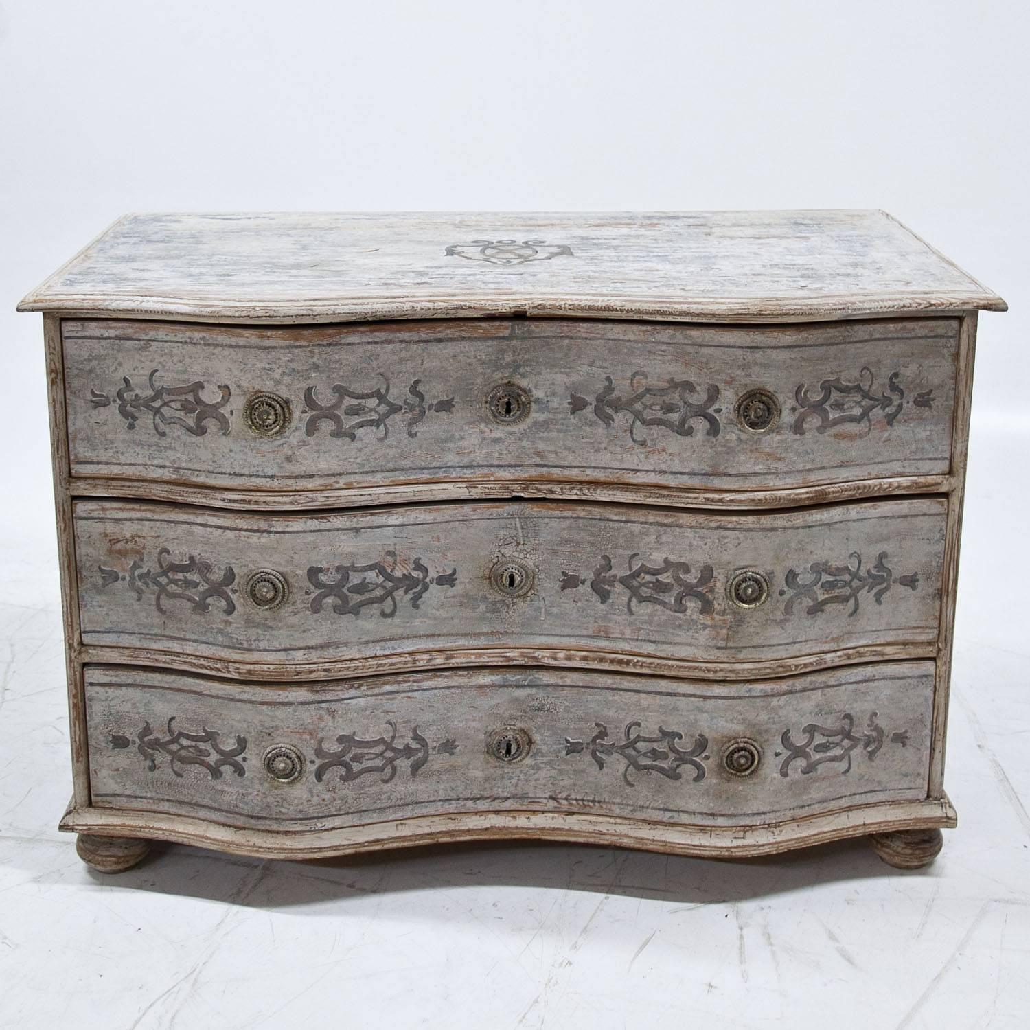 Baroque chest of drawers on bun feet with three drawers and a serpentine front. The Gustavian-style paint is new and done after traditional models. The chest has a decorative worn look to it.