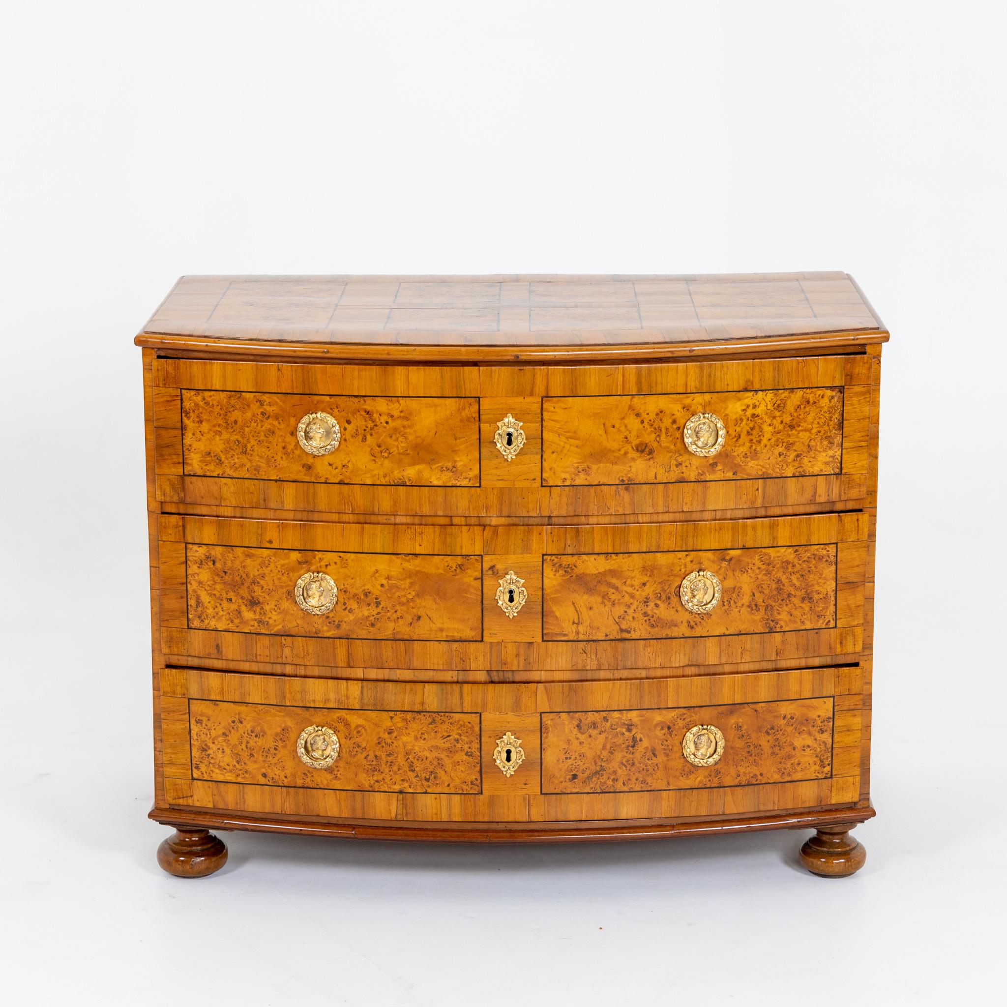 Baroque chest of drawers with three drawers and slightly bulged front on low baluster legs. Restored and hand polished condition.