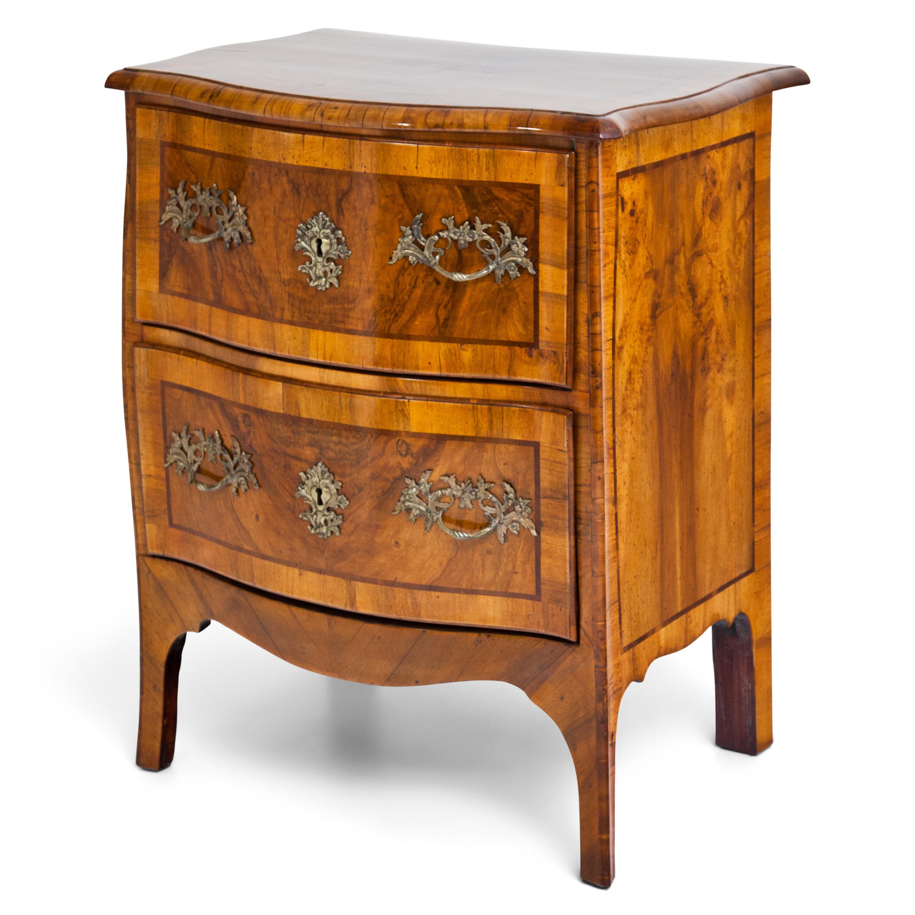 Small Baroque chest of drawered with bombé body and two drawers. Walnut veneered with ribbon inlays.