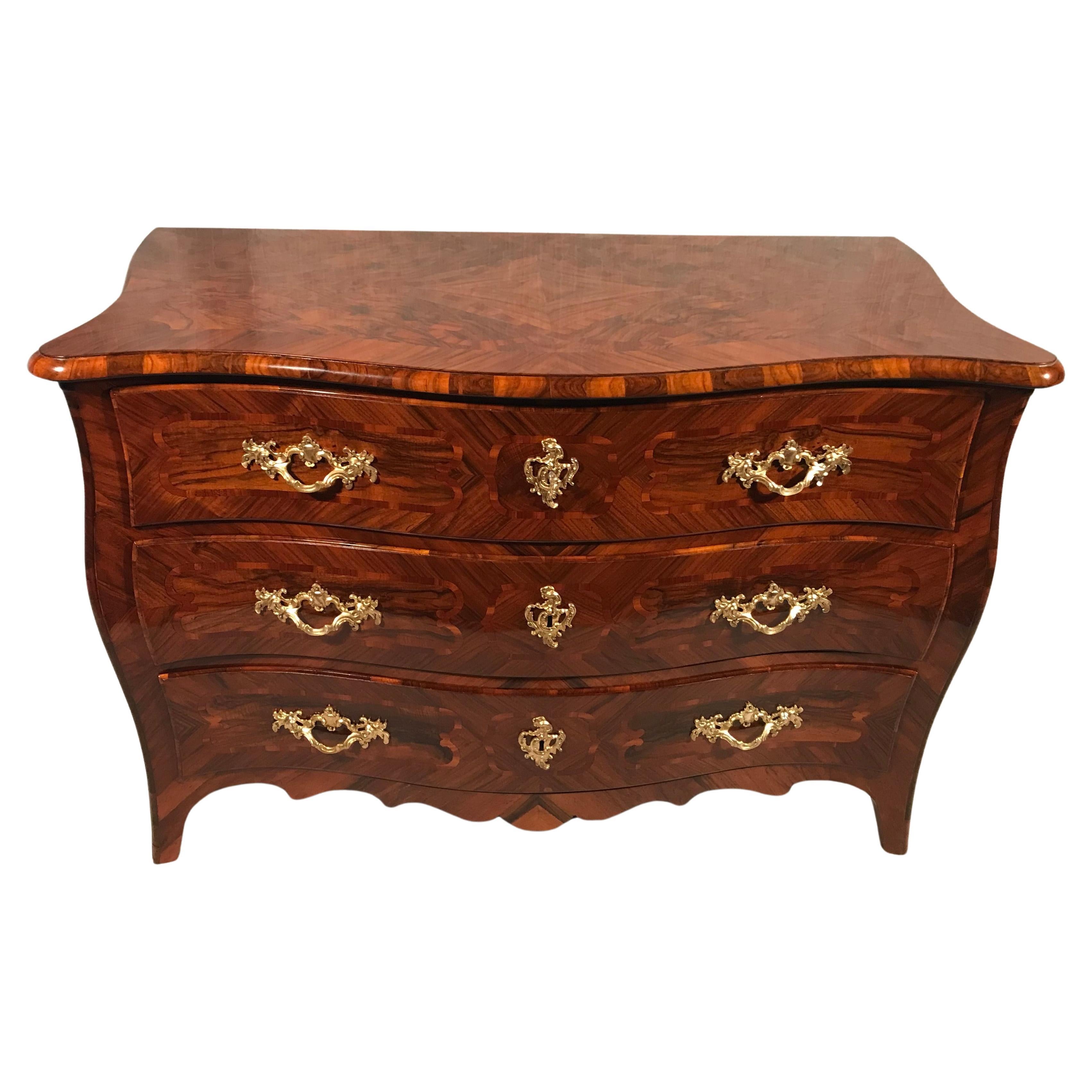 Embrace the opulence of the mid-18th century with this stunning Baroque chest of drawers from southern Germany. This exceptional piece showcases the grandeur and intricate craftsmanship of the Baroque period.

Features:

Historical Elegance: Dating