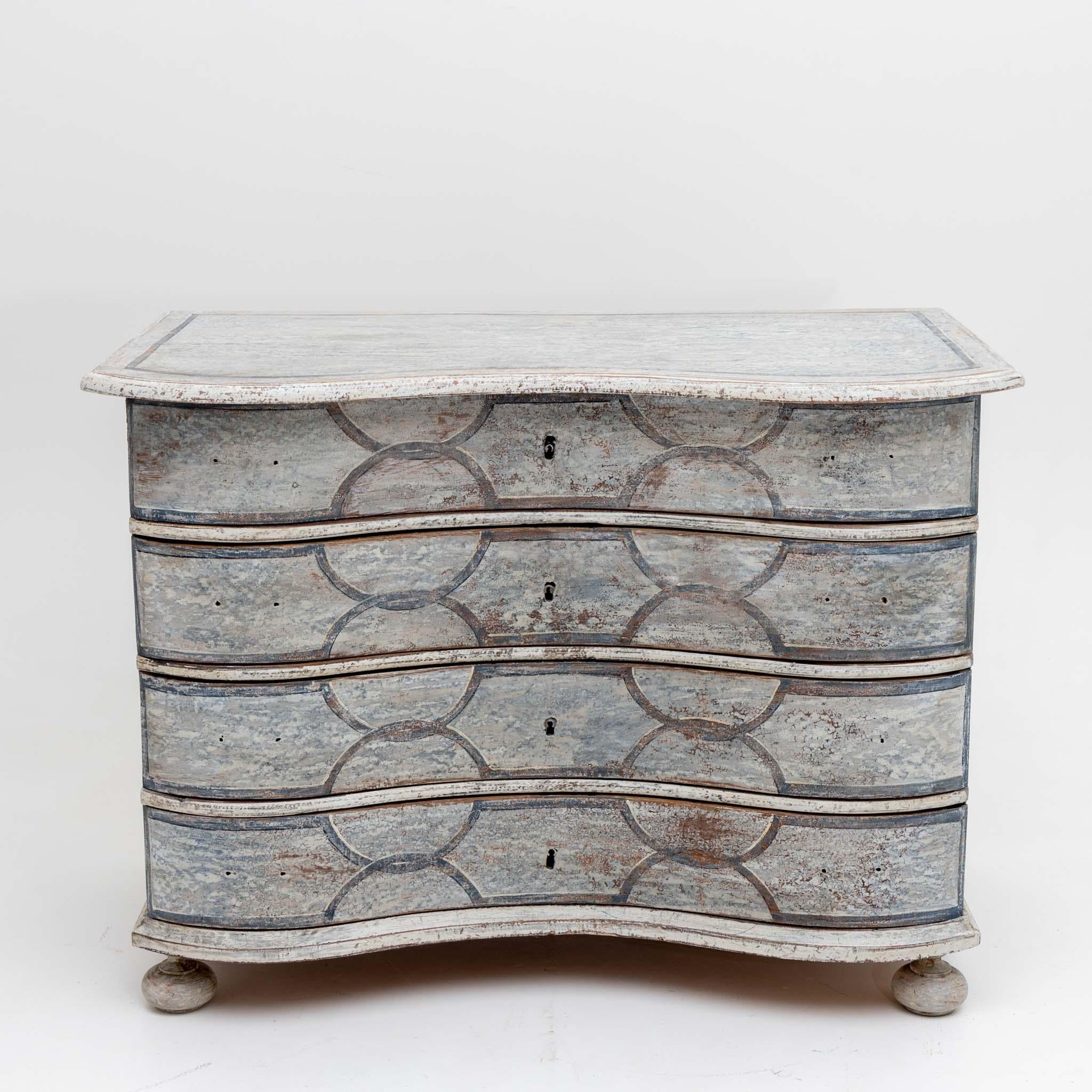 Baroque chest of drawers on ball feet and a curved corpus with four drawers and painted bandelwerk.