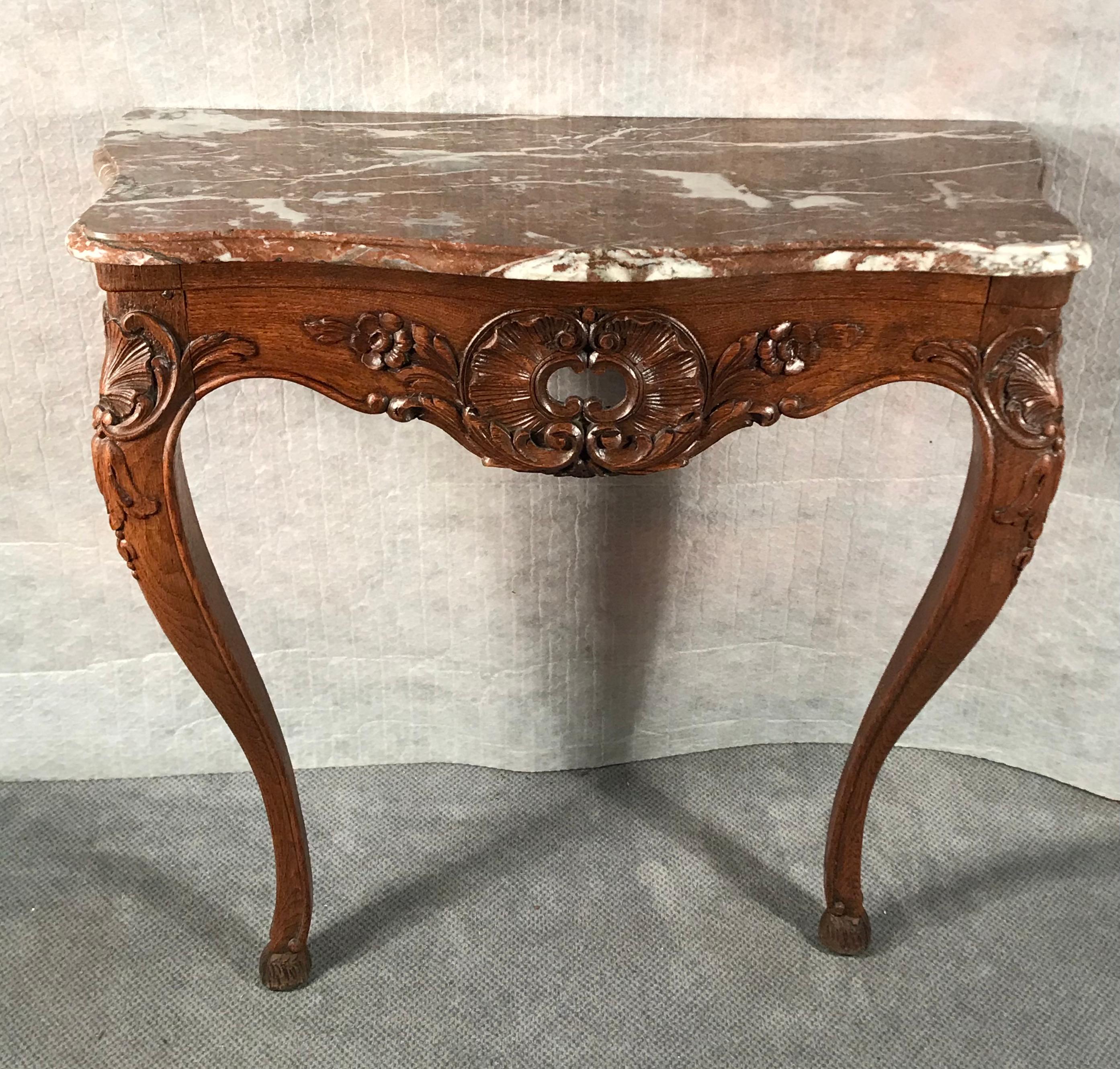 Baroque console table, Germany 1750.
The console table stands out for its finely carved oak wood floral decoration. The marble top is original. 
The console table is in very good condition.
      