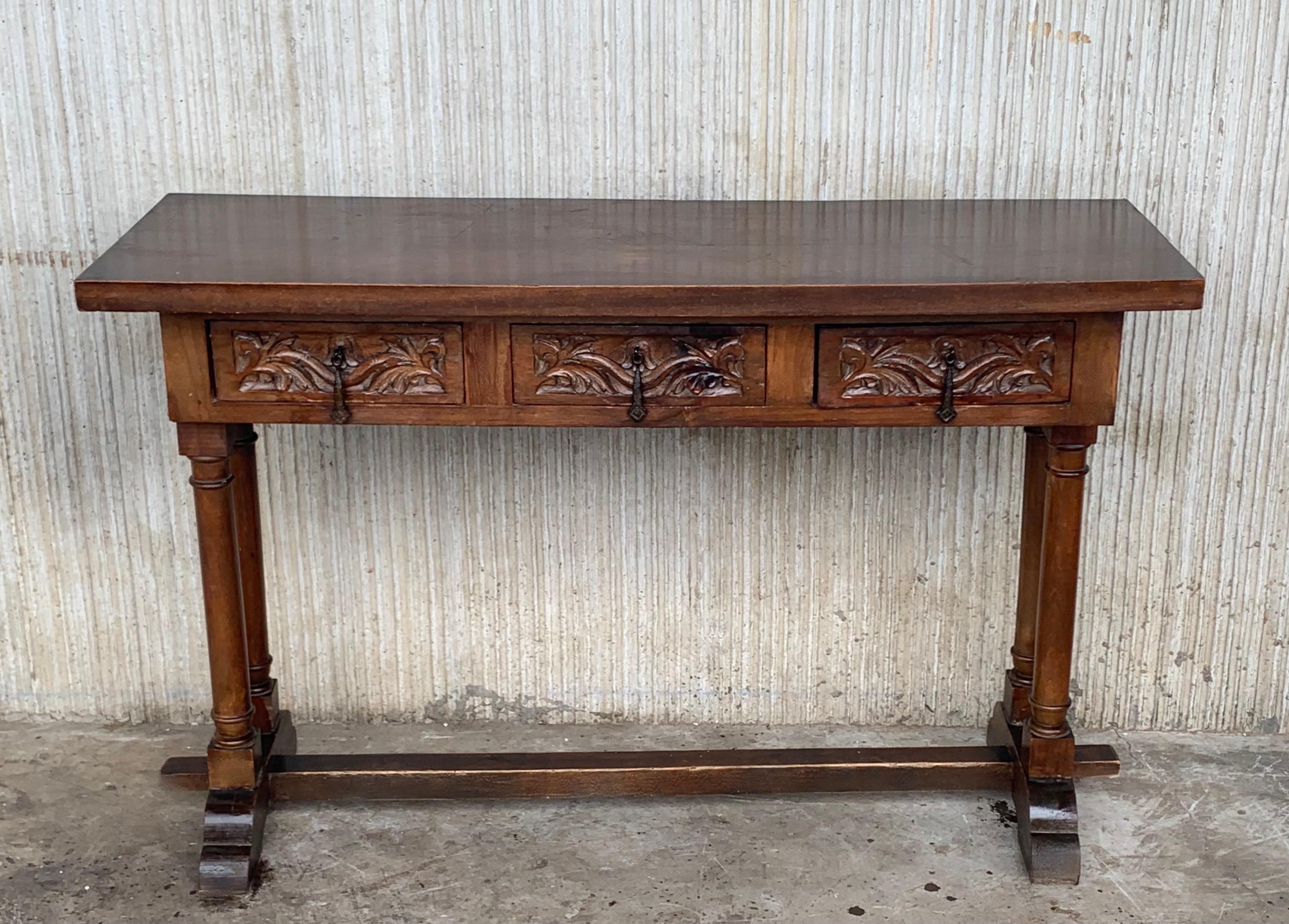 19th century Spanish Baroque console table in walnut with three carved drawers and wood stretcher.