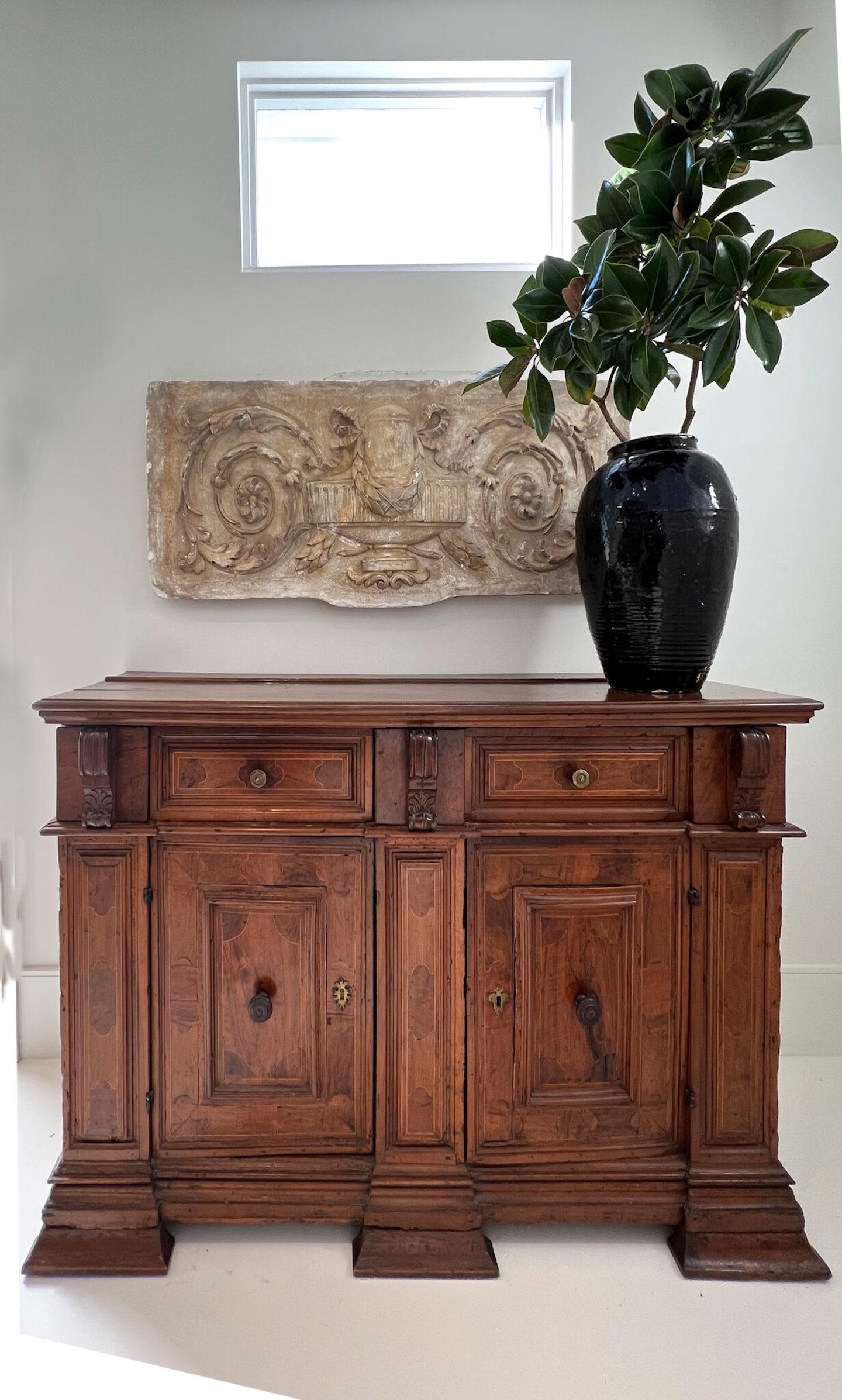 17c Italian Baroque buffet or credenza with two drawers over two doors, five drawer, with 3 hidden drawers over the columns. Made of inlaid walnut, with bronze and wood pulls.
 