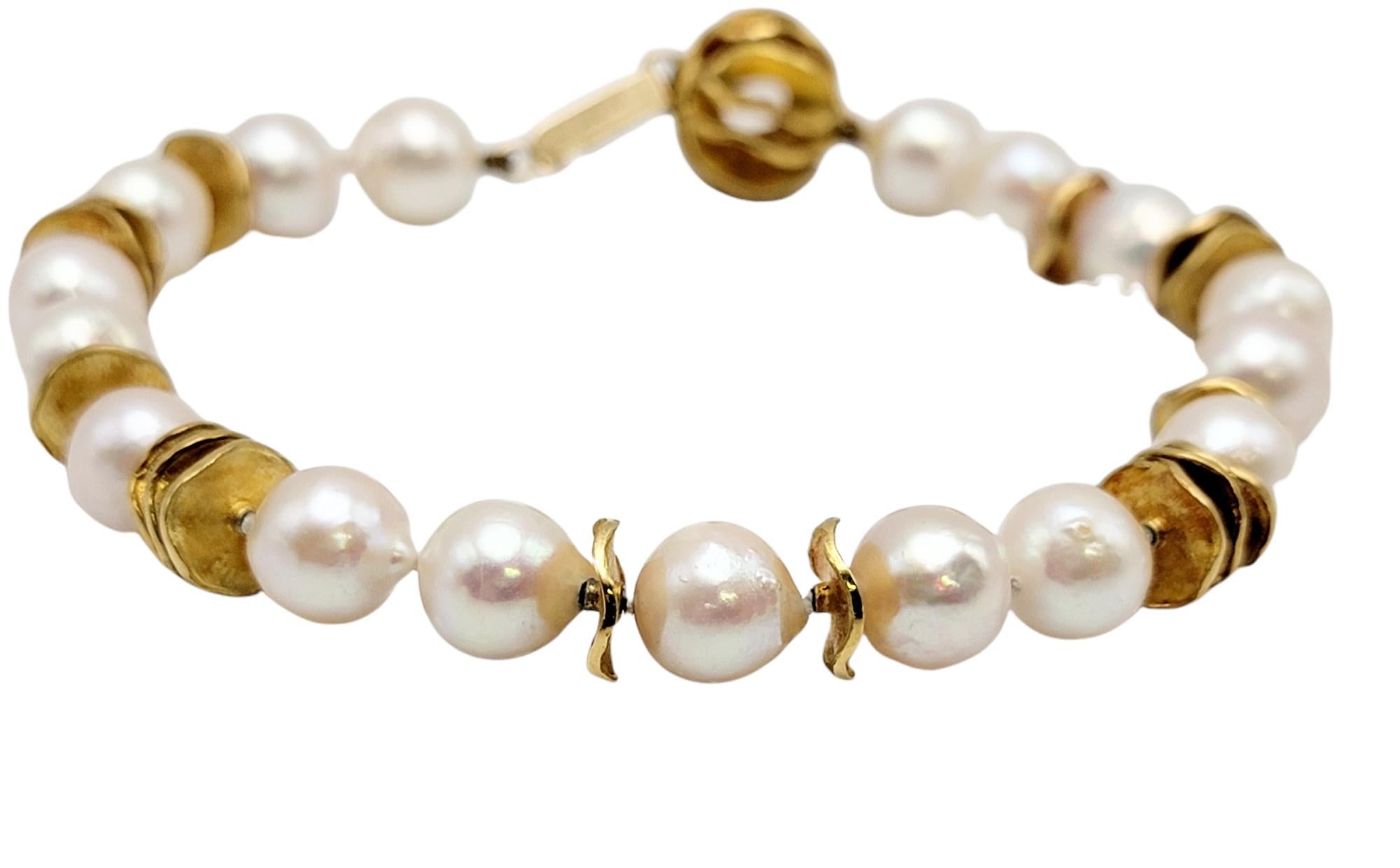 Beautiful timeless Cultured Akoya pearl and 14K gold bracelet. The lustrous, creamy pearls absolutely glow among the bright gold wavy discs, boasting an elegance that will stand the test of time. This gorgeous hand crafted piece will be one you will