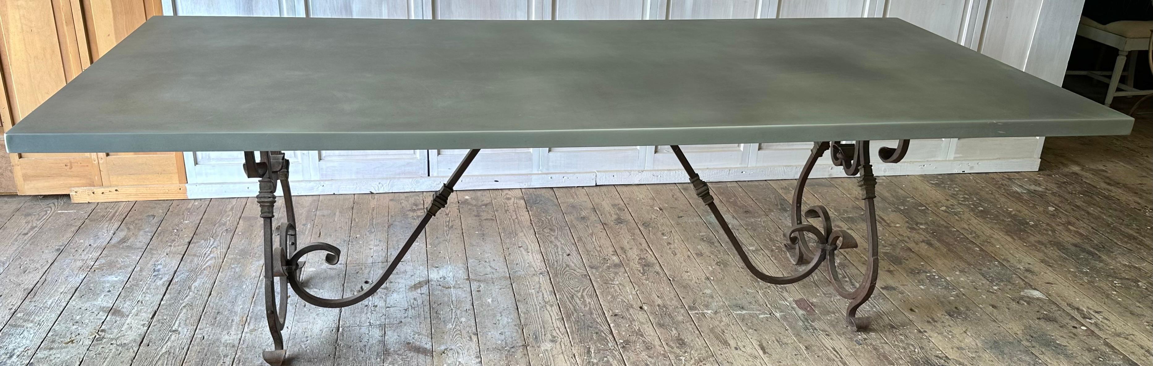 Highly decorative iron metal base with brass decorations topped with a large zinc clad rectangular table top.  Table can be used as indoor, outdoor, garden or great room. Rust can be removed and be given a wonderful finish. Elegant and rustic at the