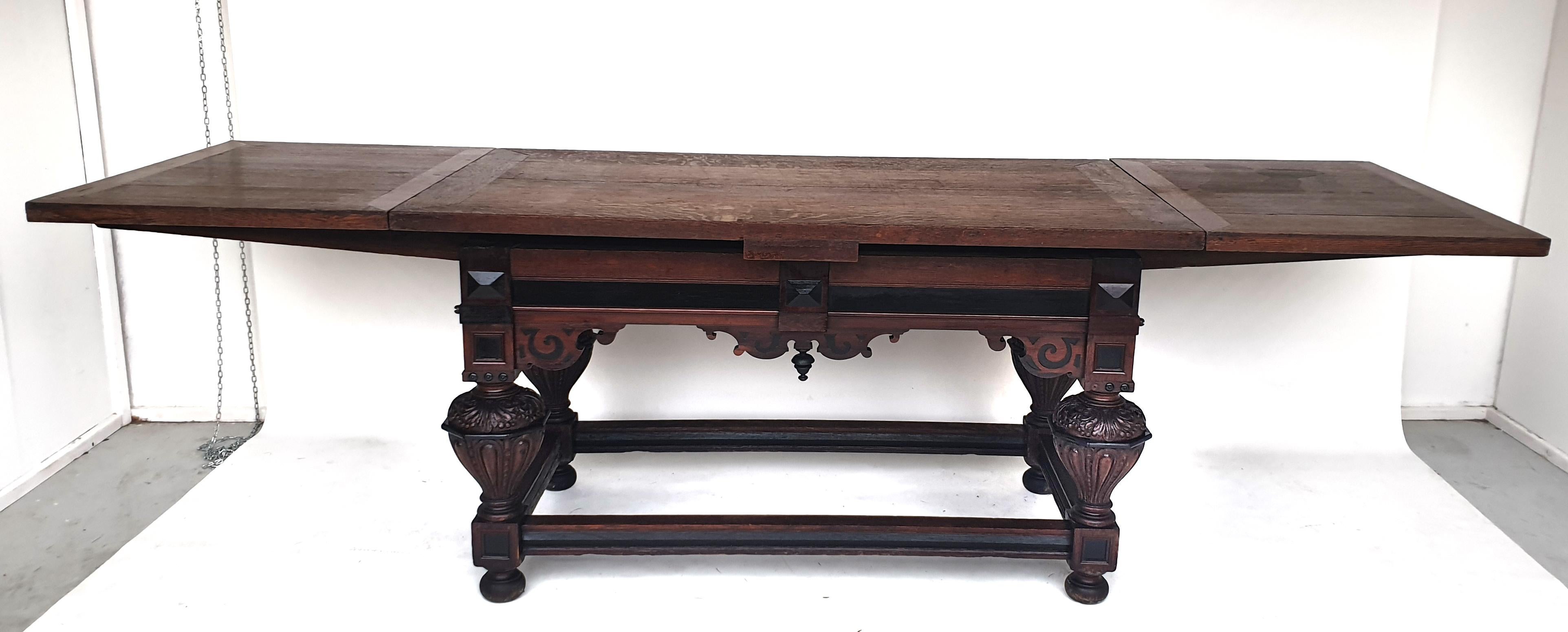 Baroque extending table, Frisia, 1750s. Made of solid oak. 

Base frame with circumferential webs and ball feet. Mighty, richly designed baluster legs with relief carvings. Frame with elaborately designed, finely cut apron with diamonds. The table