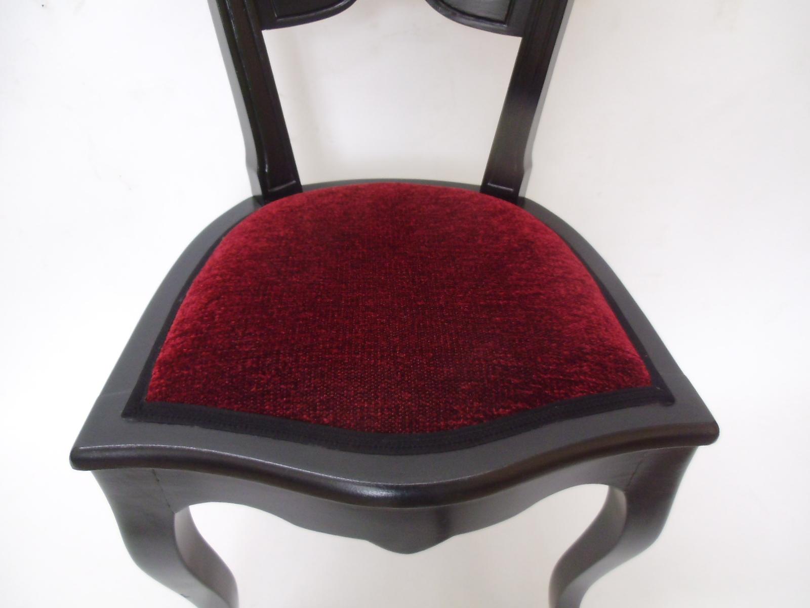 Elegant single piece Baroque chair with a black stained frame and new, red velvet upholstery. Features a classical Baroque design an elegantly carved backrest and wonderfully curved legs. Restored by hand with only high quality materials and very