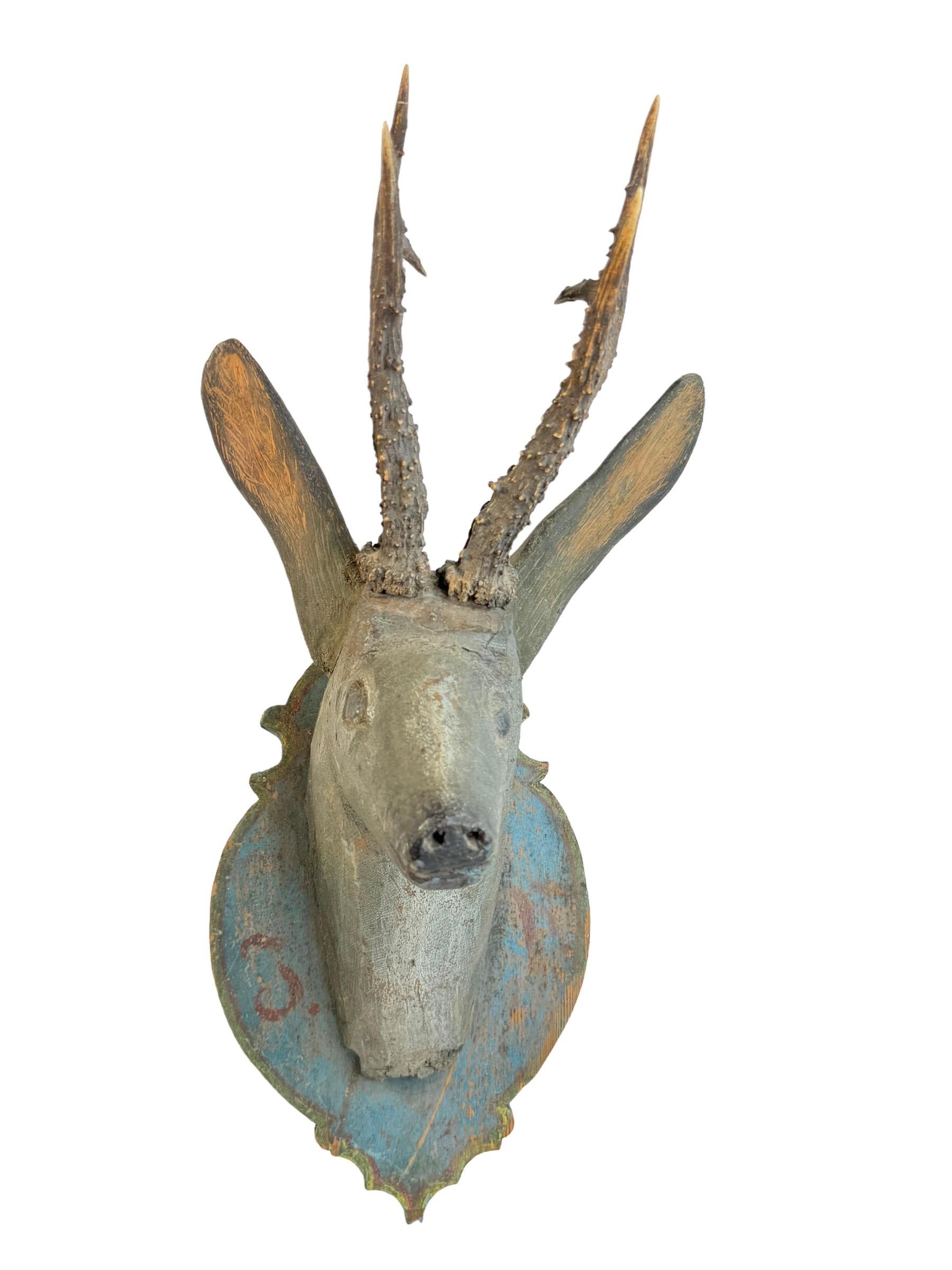 A great looking hand carved original wooden Folk Art deer head wall decoration. A great piece for a suitable ambiance in a trophy room or the office of a Hunter or Woodsman. More than likely one of the Folk Art items made between 1780 and the late