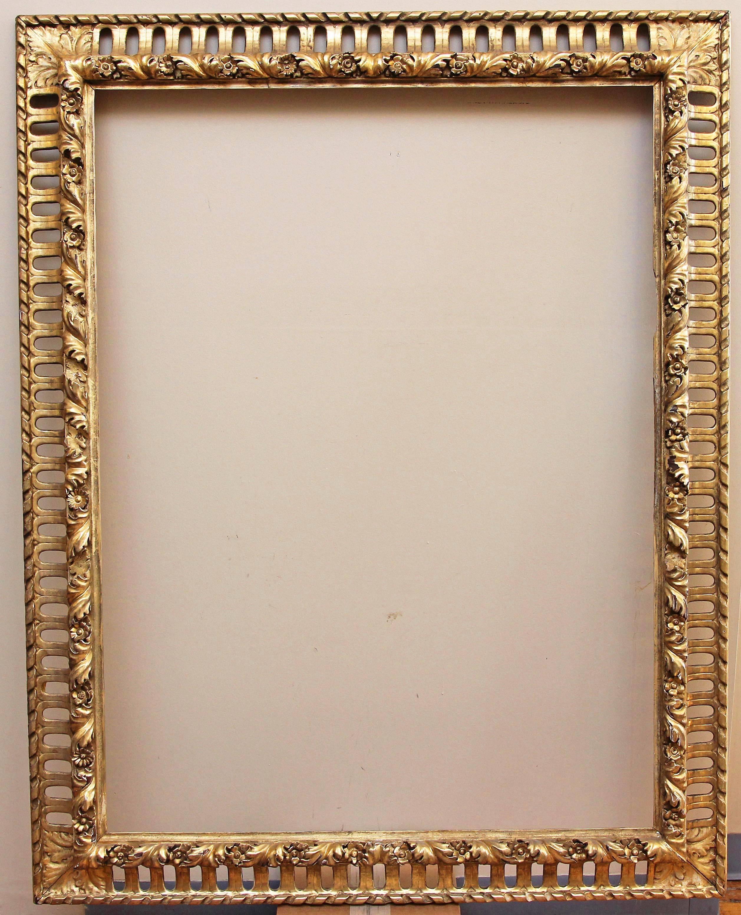 Large Italian Baroque style frame. Carved wood and original gold leaf gilding. 19th century. Opening measures: 51