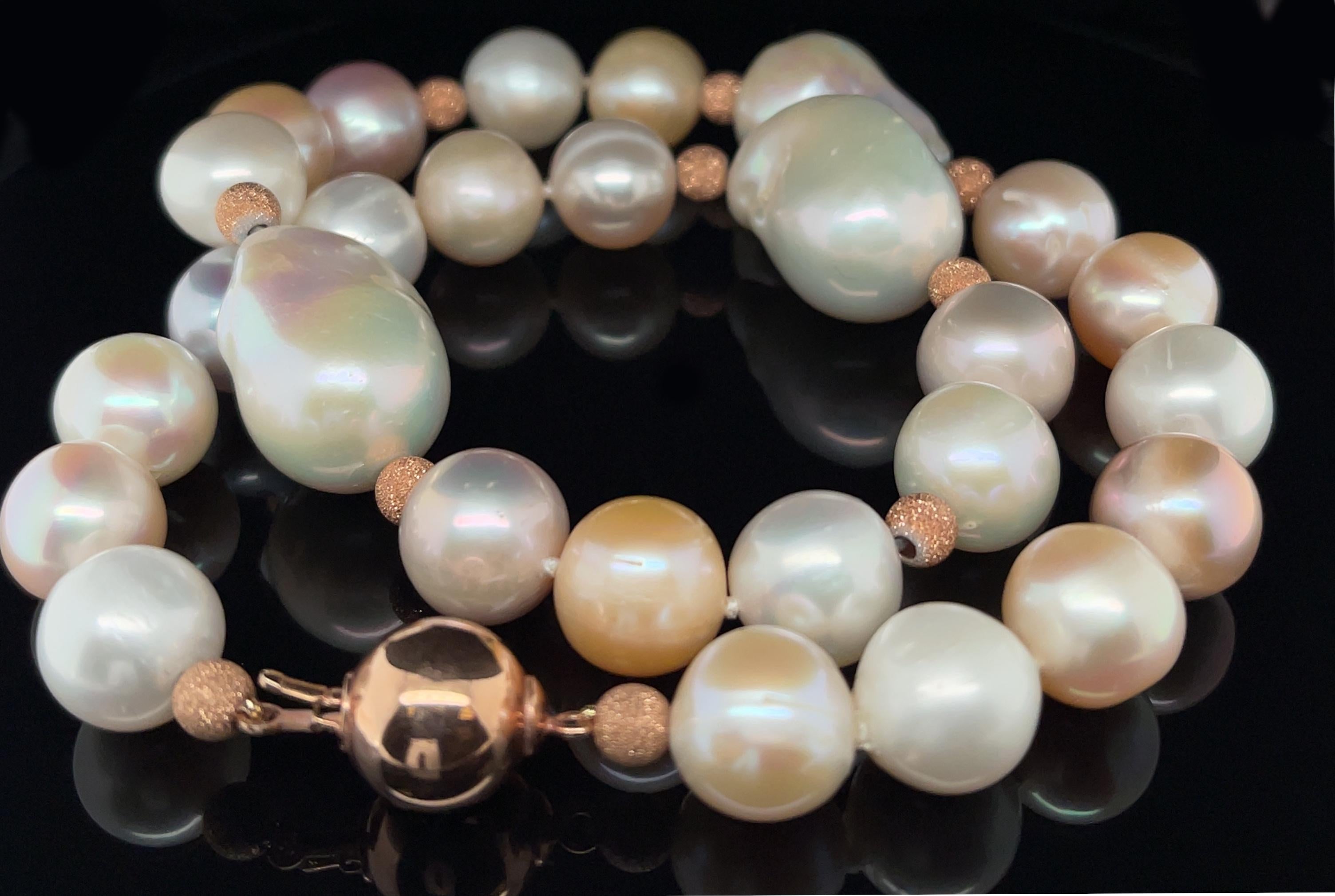 This impressive strand of large, multi-colored freshwater baroque pearls is truly eye-catching and includes Pantone's 2024 Color of The Year, fuzzy peach! Three stunning 22.5mm white baroque pearls have been combined with lustrous, 11.00mm