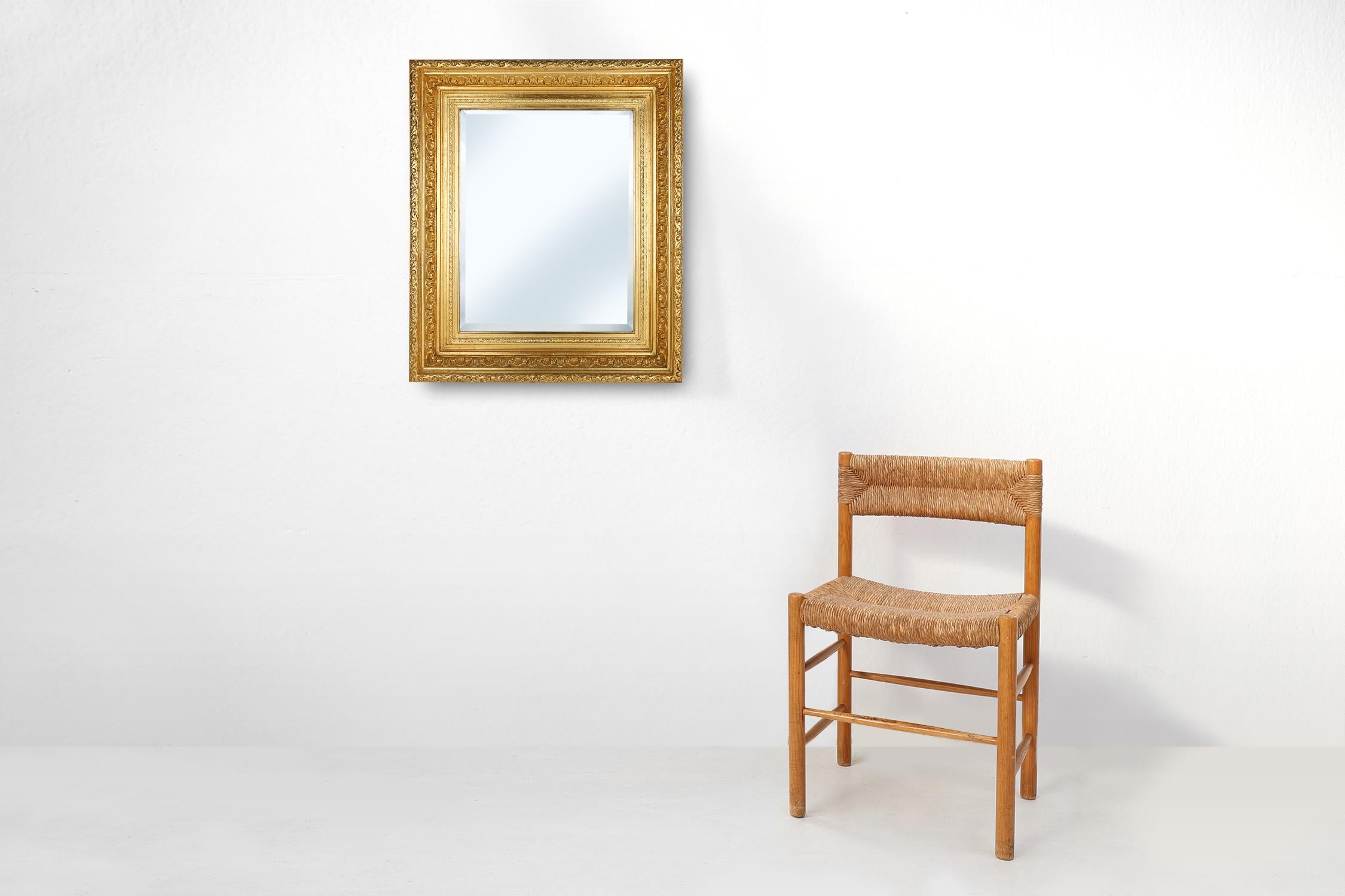 France / 1850 / mirror / wood and plaster / Baroque / Rococo / Mid-century

A highly decorative Baroque or Rococo gilt wooden square mirror with bevelled mirror. The mirror displays a beautiful bold and richly carved frame with floral details. 

Its