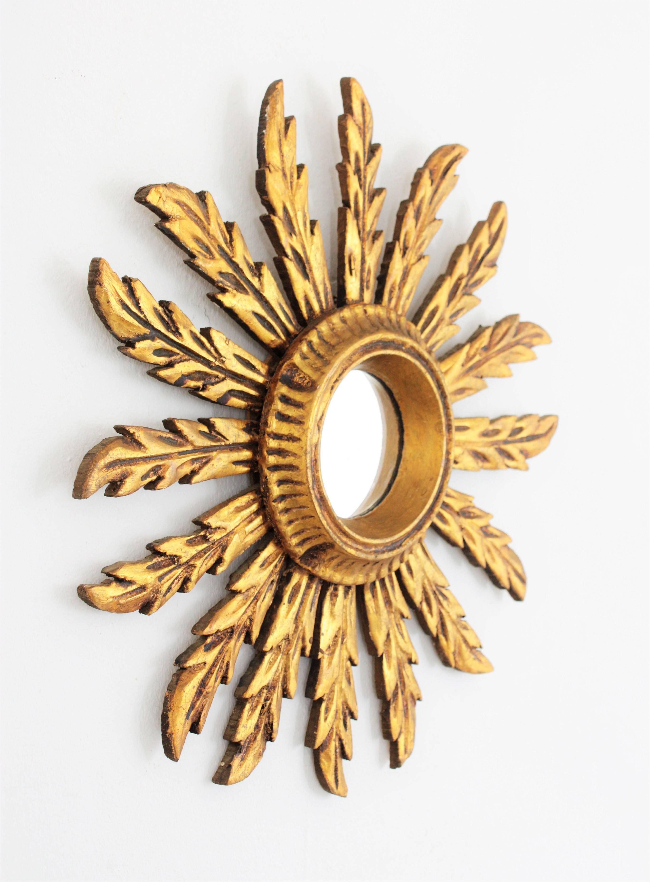 Beautiful unusual small sized Baroque style giltwood sunburst mirror. Carved wood, covered with gesso and gold leaf finish.
The frame has a lovely patina. Dimensions of the glass: 8cm.
Spain, 1920s-1930s.


 