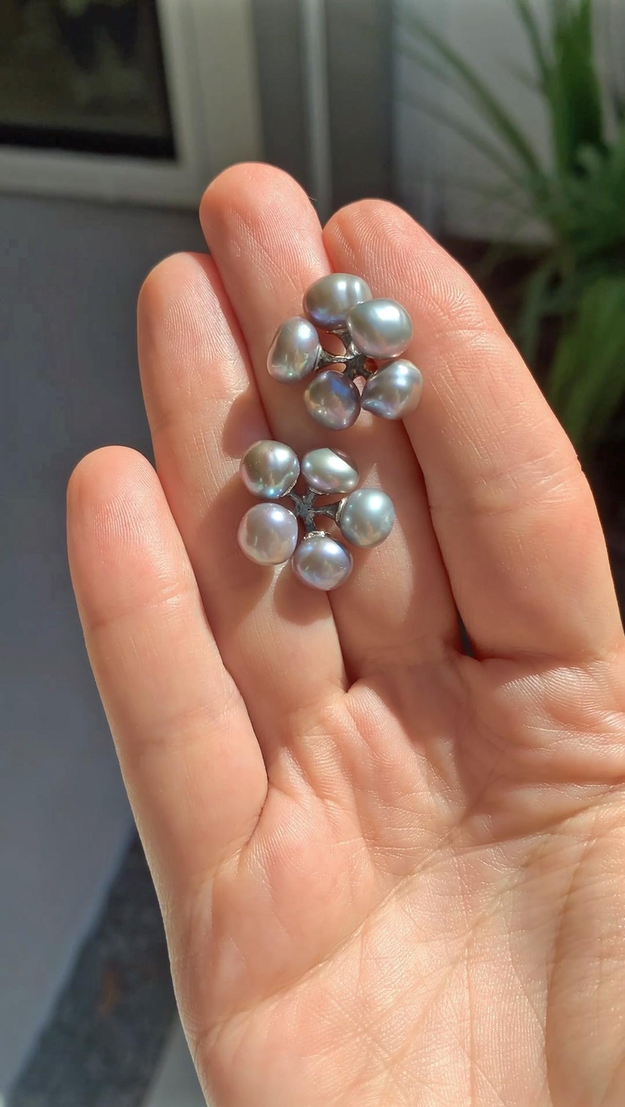 Jax Earrings handcrafted by world-renowned jewelry maker John Iversen in oxidized sterling silver showcasing ten perfectly matched silver blue gray baroque keshi pearls and finished with 18k yellow gold posts with sterling silver backs. Stamped 750.