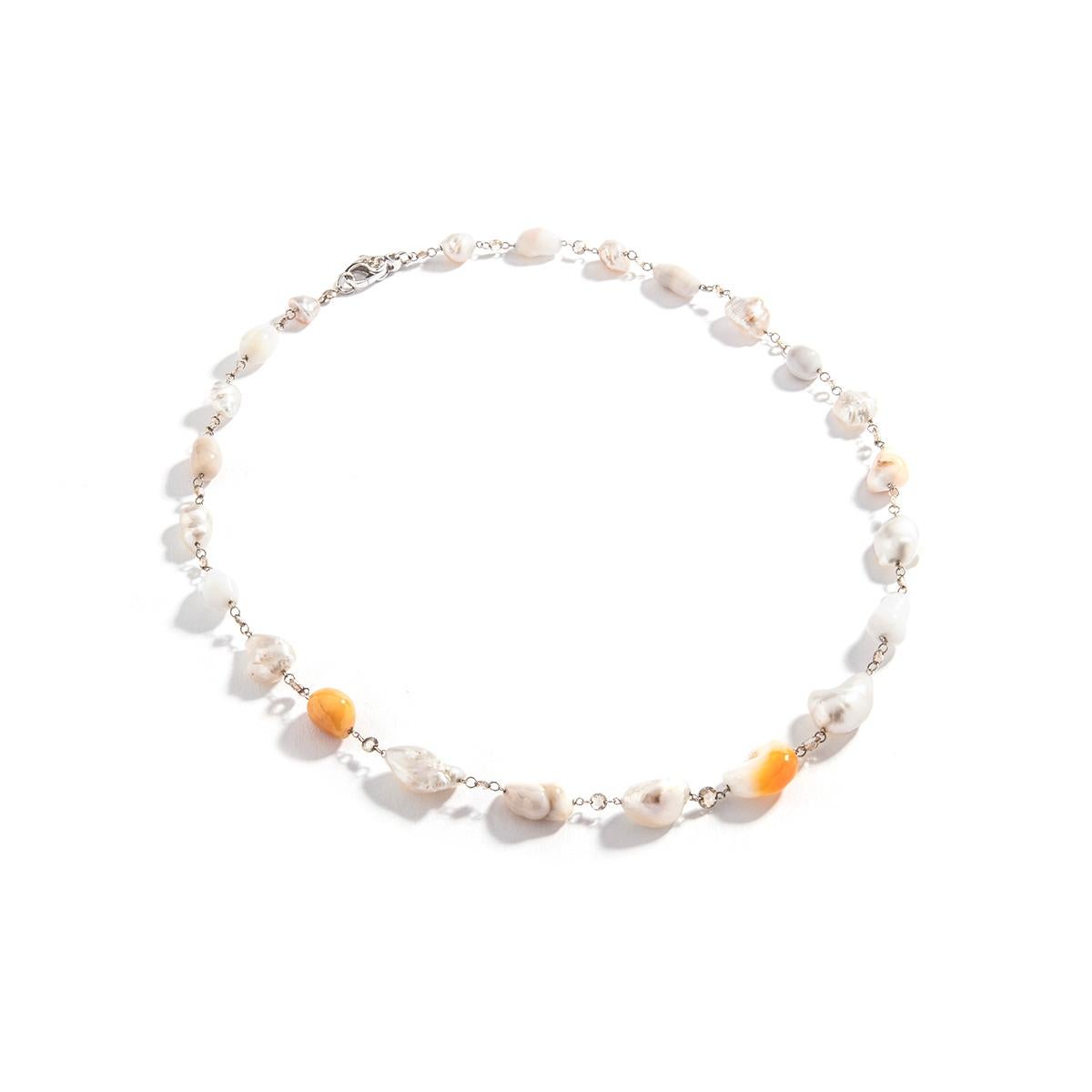 Baroque Culture Melo and White Pearl and Rose cut Diamond Necklace. White gold 18k.
Natural Pearl color.
Diamond Natural brown color.
Length: 18.50 inches (47.00 centimeters).
Total weight: 24.19 grams.

Former property of a French Lady.

We are