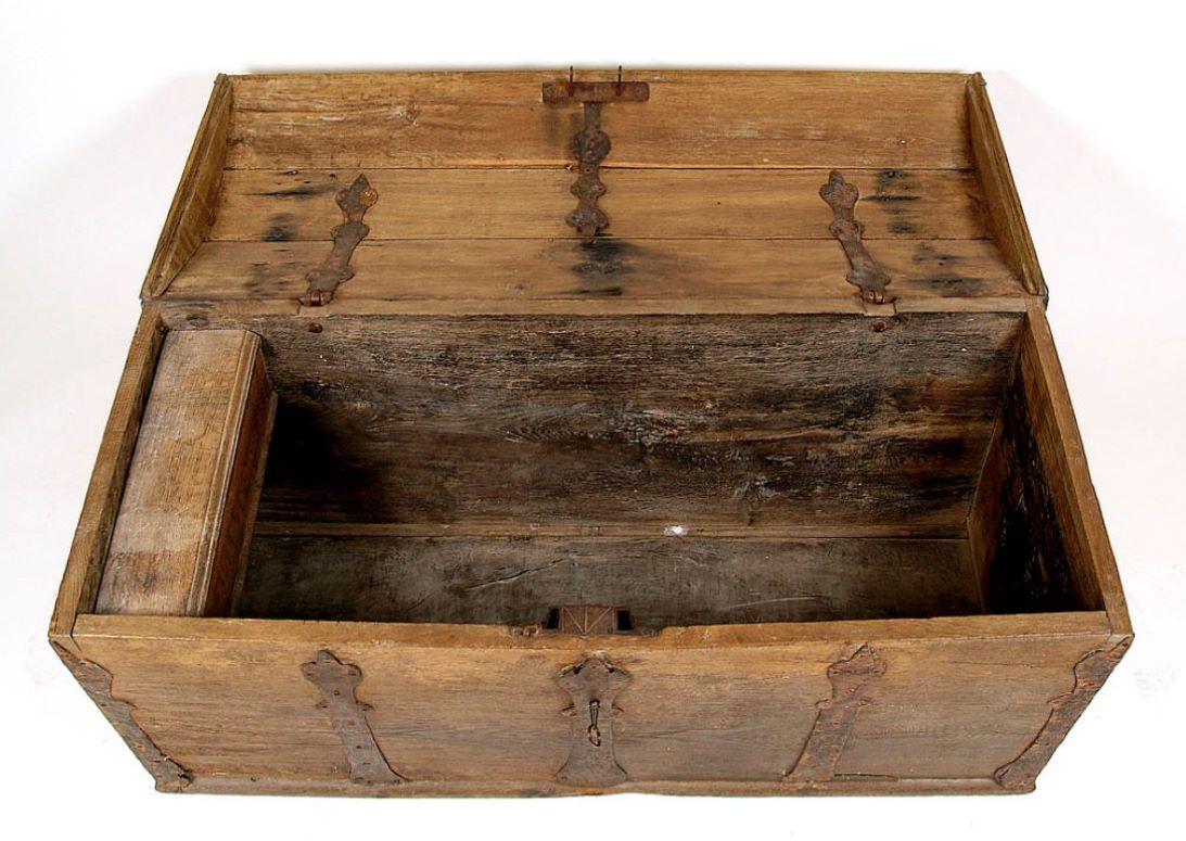 Baroque oak chest from the mid-18th century
with straight, tapering down sides, closed with a folded, convex lid. Fitted with decorative strips made of steel sheet, on the side walls forged iron bolts with locks.
Forged steel overlay lock with two