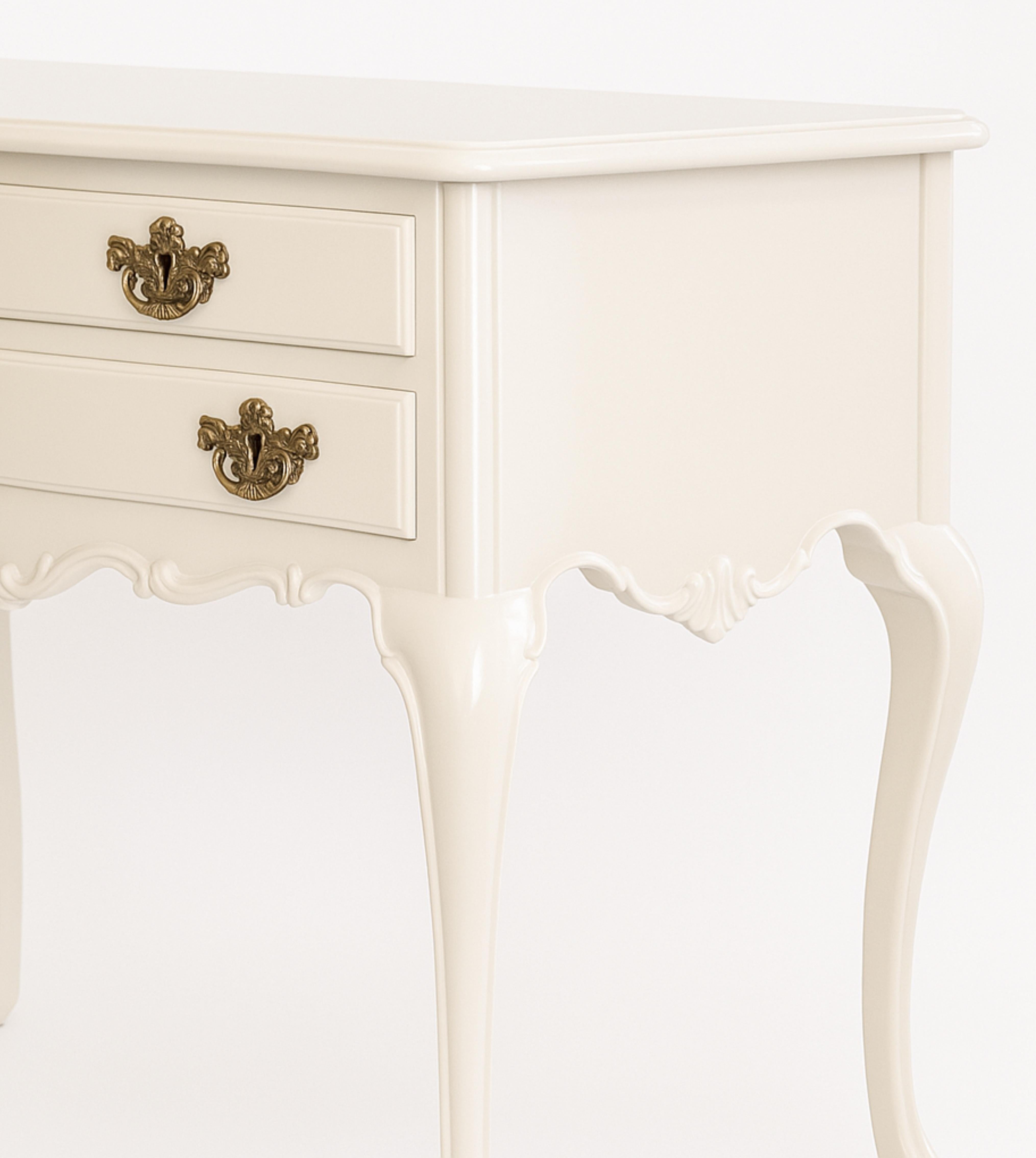 A off white lacquer refinished walnut baroque style table commode with two drawers, vegetative marquetry skirt and bombée legs, three drawer and gilded hardware