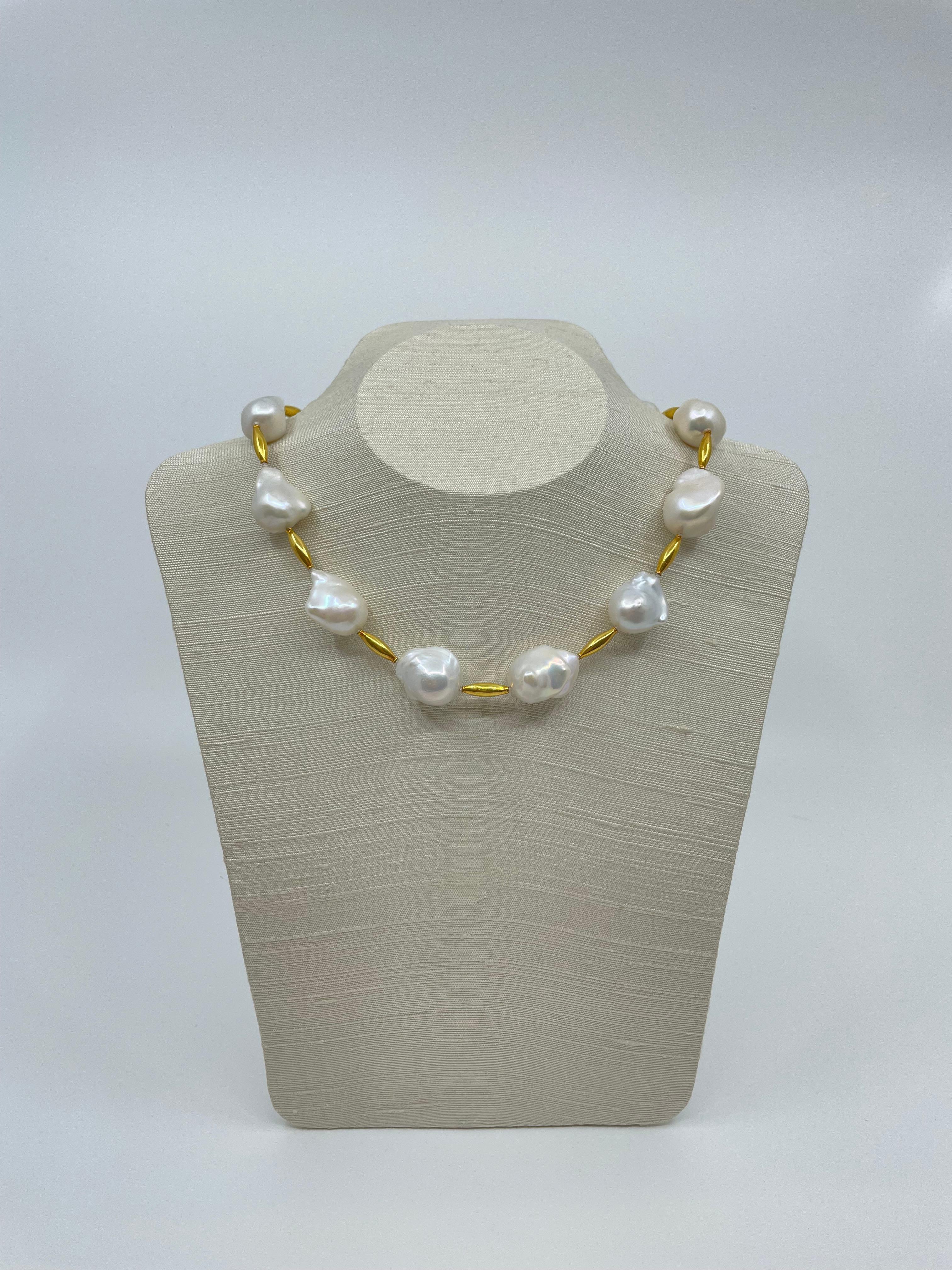A statement necklace, the organic-formed baroque pearls are spaced by 18k gold tube-shaped beads and closes with an 18k gold toggle clasp. The pearls are lustrous and this 17.25