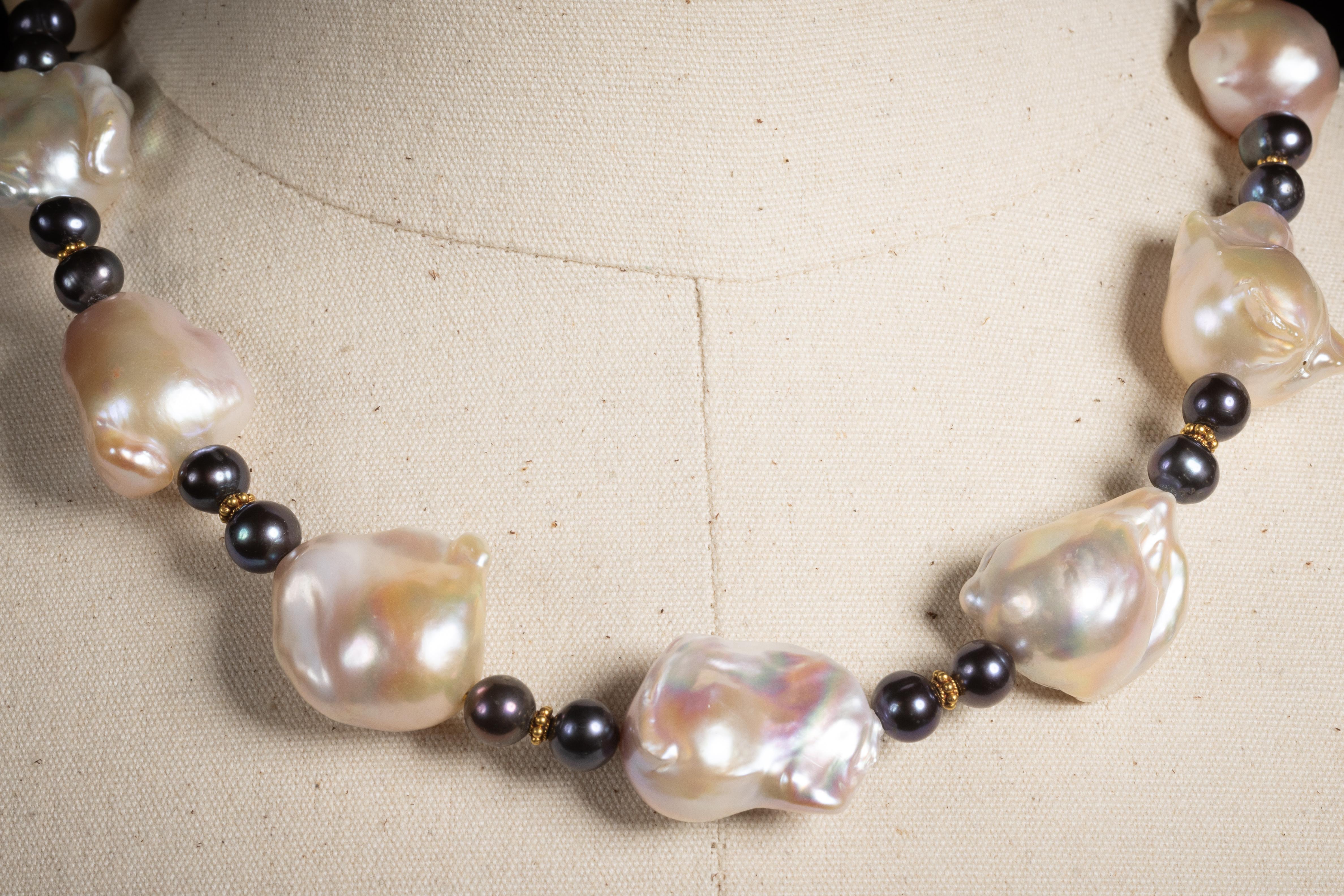 A beaded necklace by Deborah Lockhart Phillips of large 20 x 25mm baroque pearls with round black Tahitian pearls and 22K gold spacers.  The length can adjust from 19.5