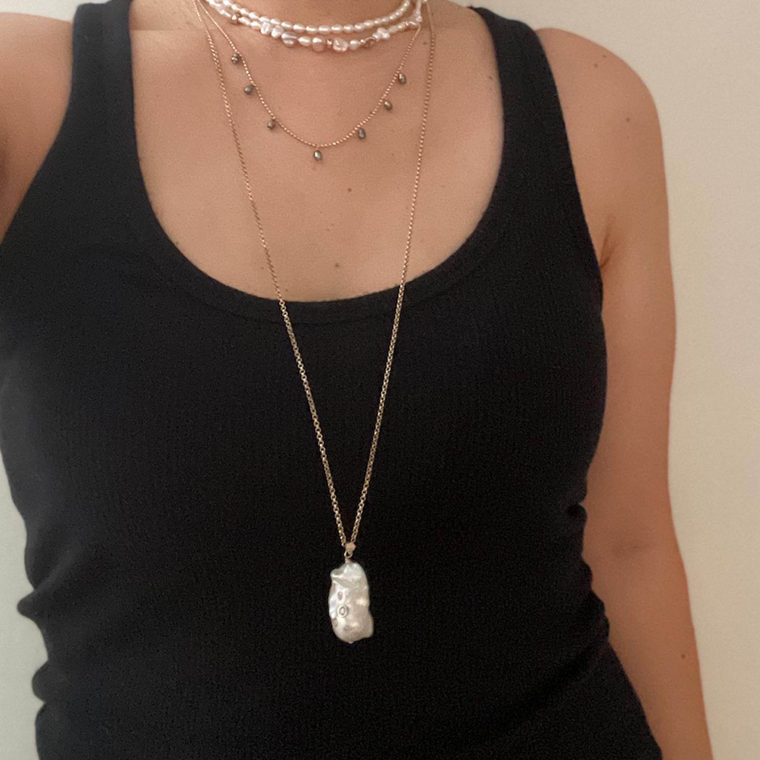 This is a statement Baroque Pearl pendant inlaid with Diamonds on heavy cable chain, making it perfect for layering with your favorite chains, pearls and necklaces.

Looks great from day to night, over a tank top or turtleneck this pearl pendant is