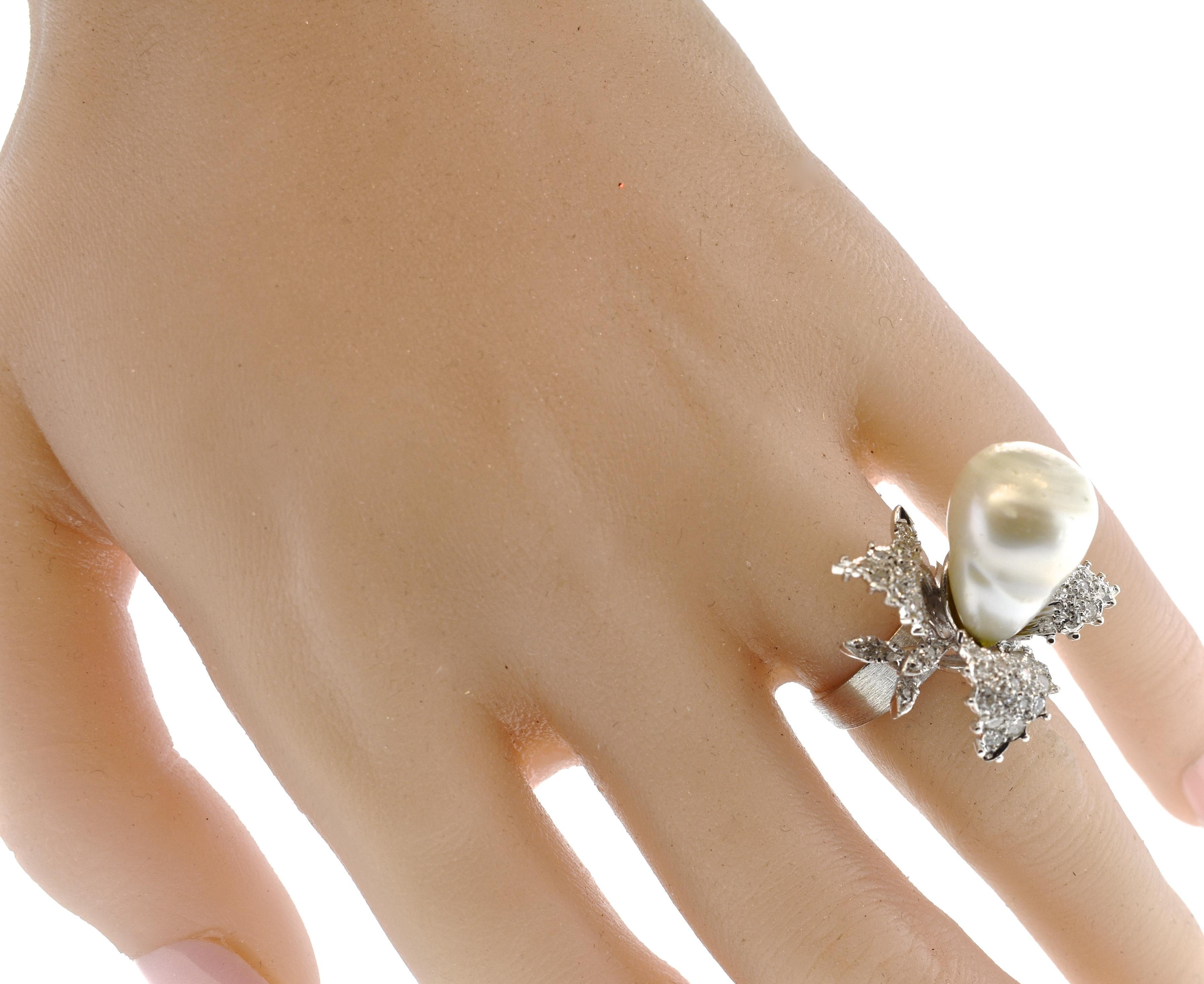 Baroque pearl set in and center and accented with over 50 white diamonds, pave set in the 