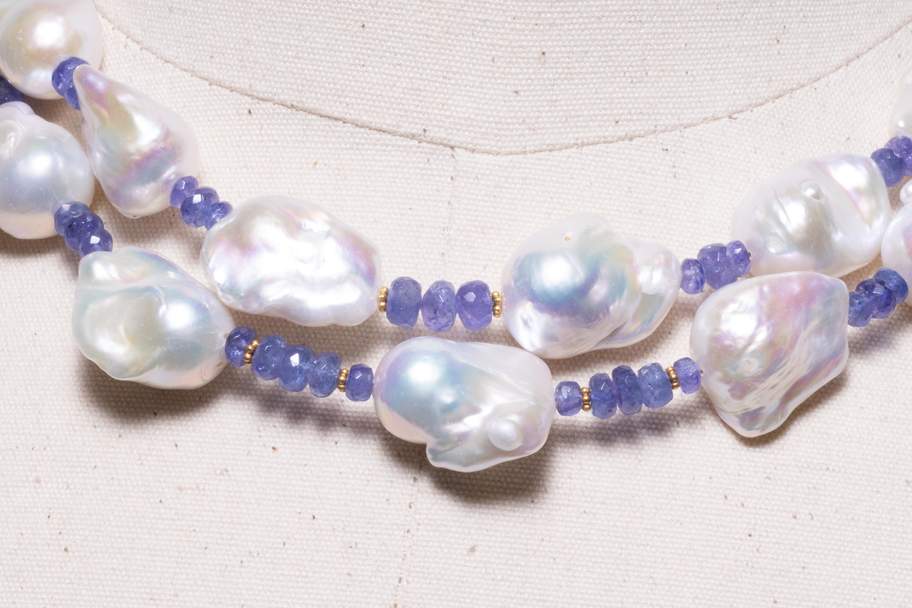 A double strand of large, white, baroque pearls with faceted tanzanite beads and 18K gold spacers.  Blush baroque pearls along the back.  18K gold S-hook clasp with center pearl.  By Deborah Lockhart Phillips
