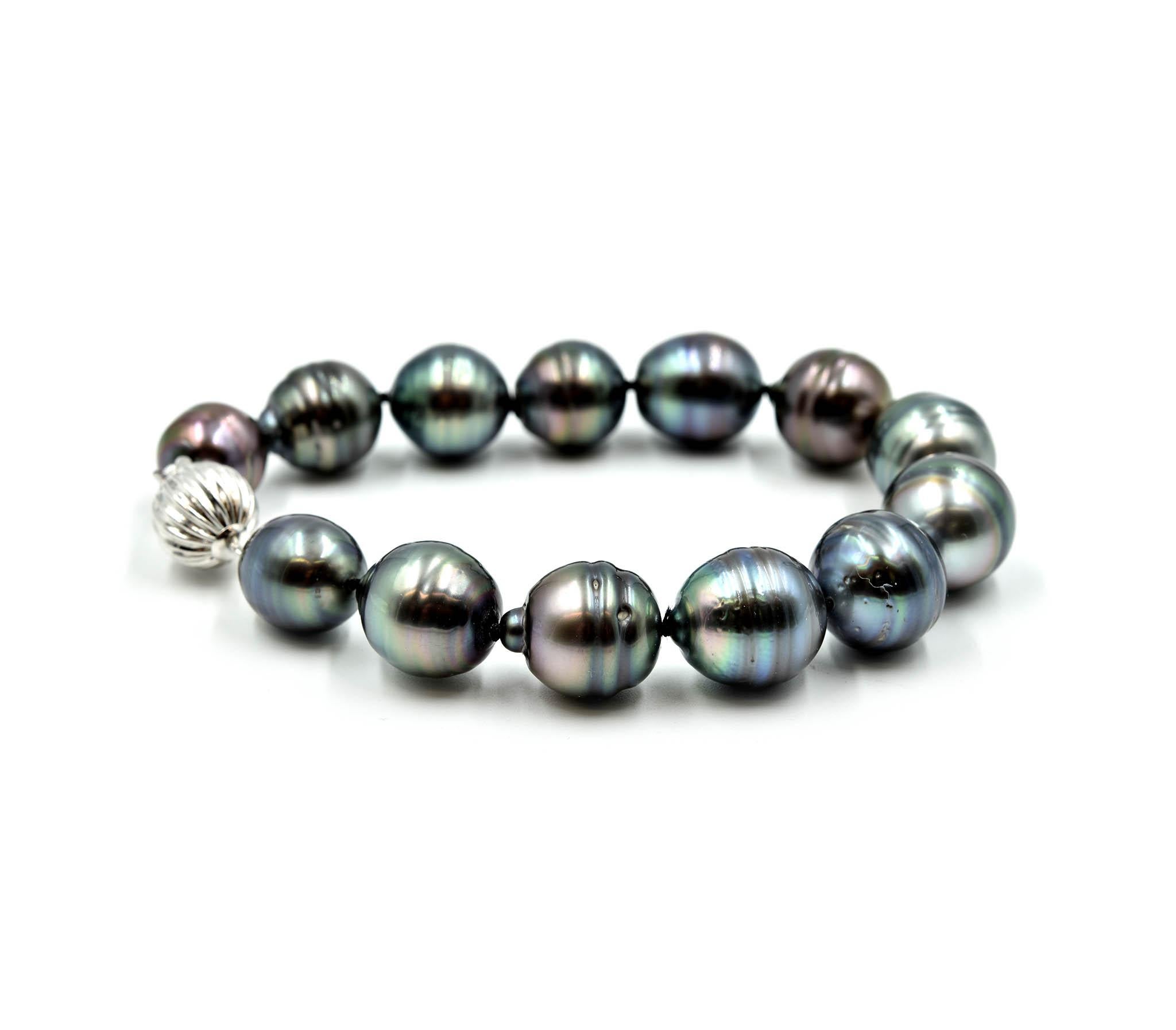 Designer: custom design
Material: 14k white gold clasp
Pearls: 12mm – 12.50mm black baroque pearls
Dimensions: bracelet is 7 ½ inches long and ½ inch wide
Weight: 36.73 grams
