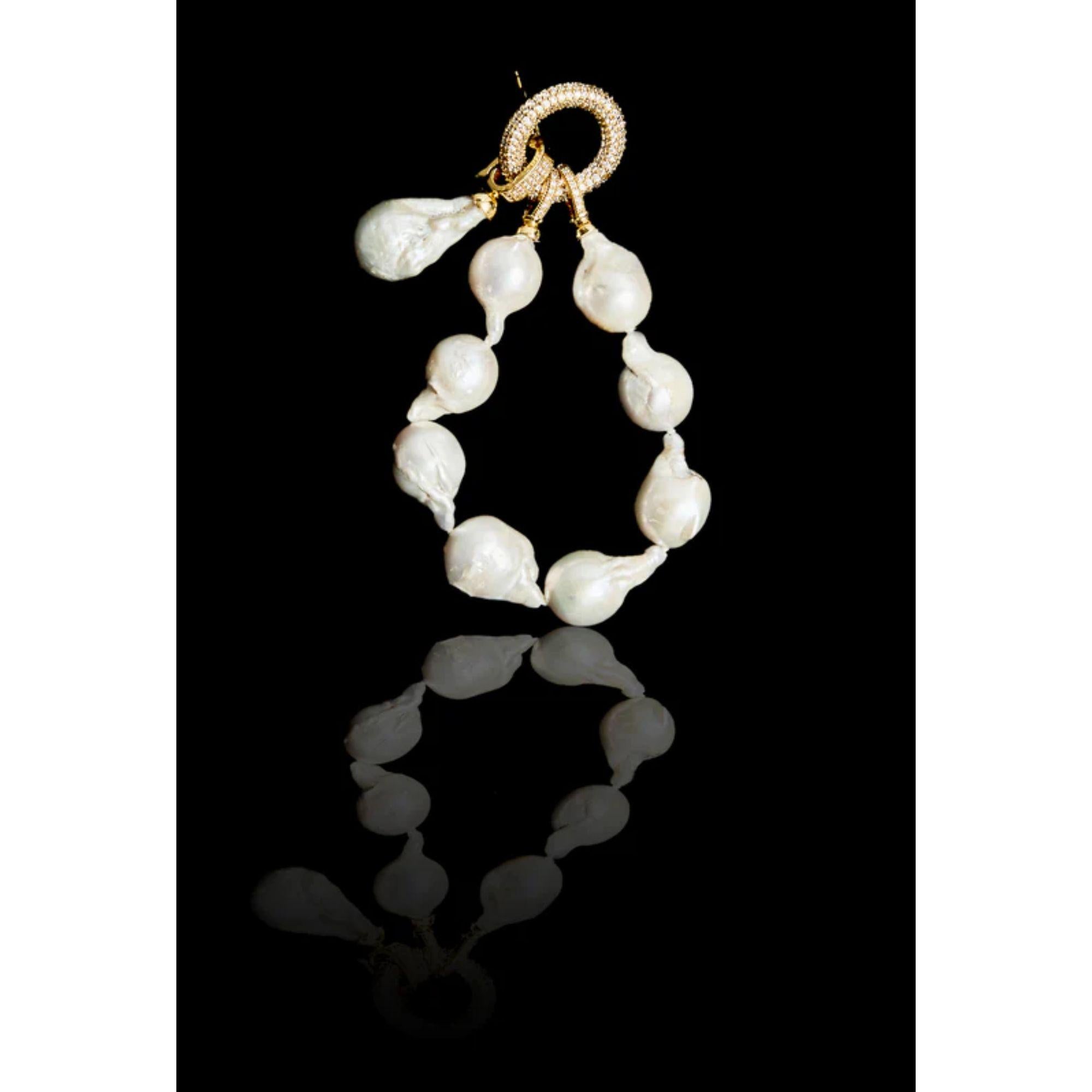 Pearl bracelet with genuine baroque pearls with an adorned lock shining with crystals and a removable oversized genuine baroque pearl charm. Goes perfect with the double pearl ring and the matching baroque pearl harness