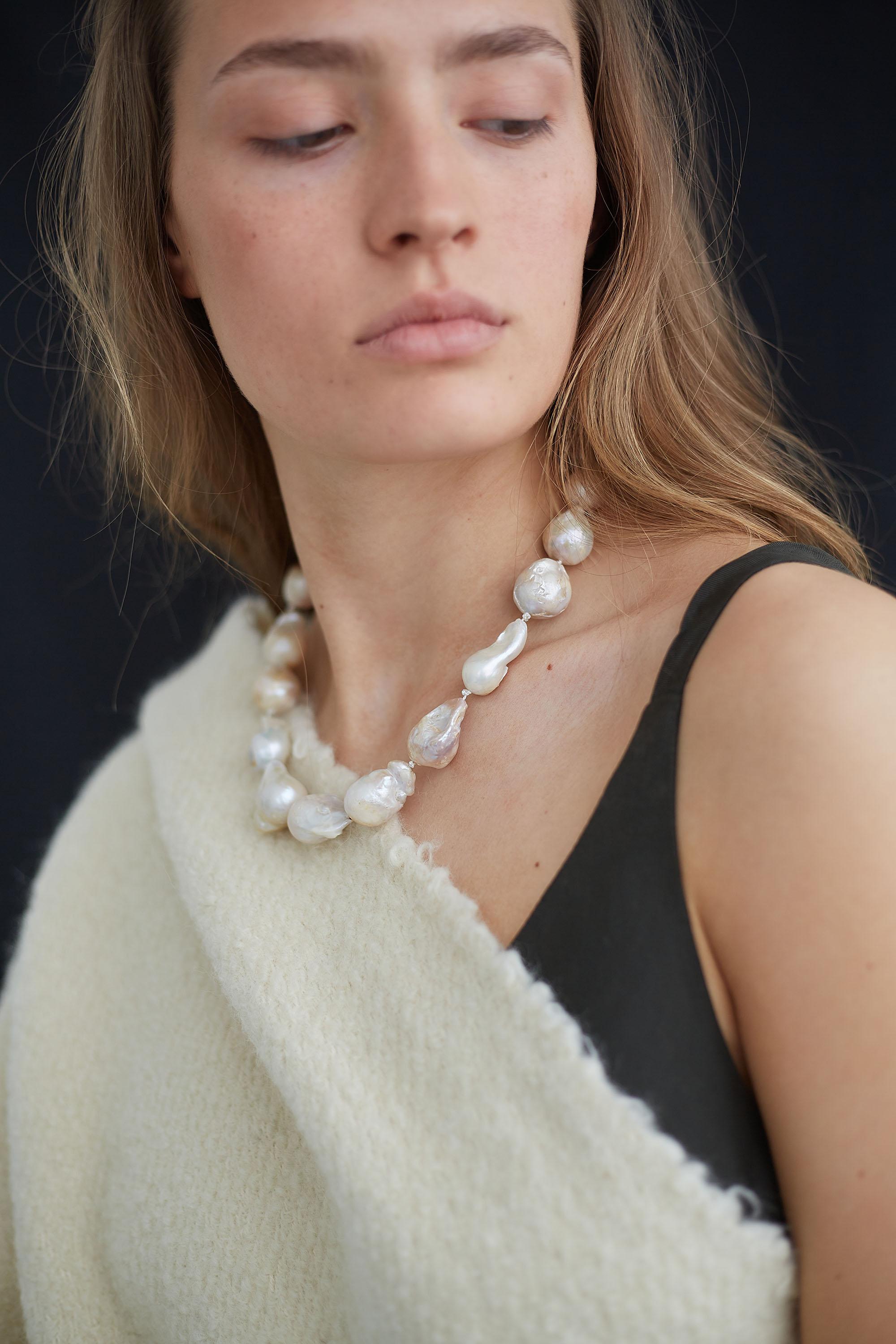 Elegant collar with stunningly irregular baroque pearls. A statement piece worn beautifully on its own . Each baroque  pearl is carefully threaded on silk thread. Sterling silver 24k gold plated toggle closure at back.   
Baroque Pearls / Gold