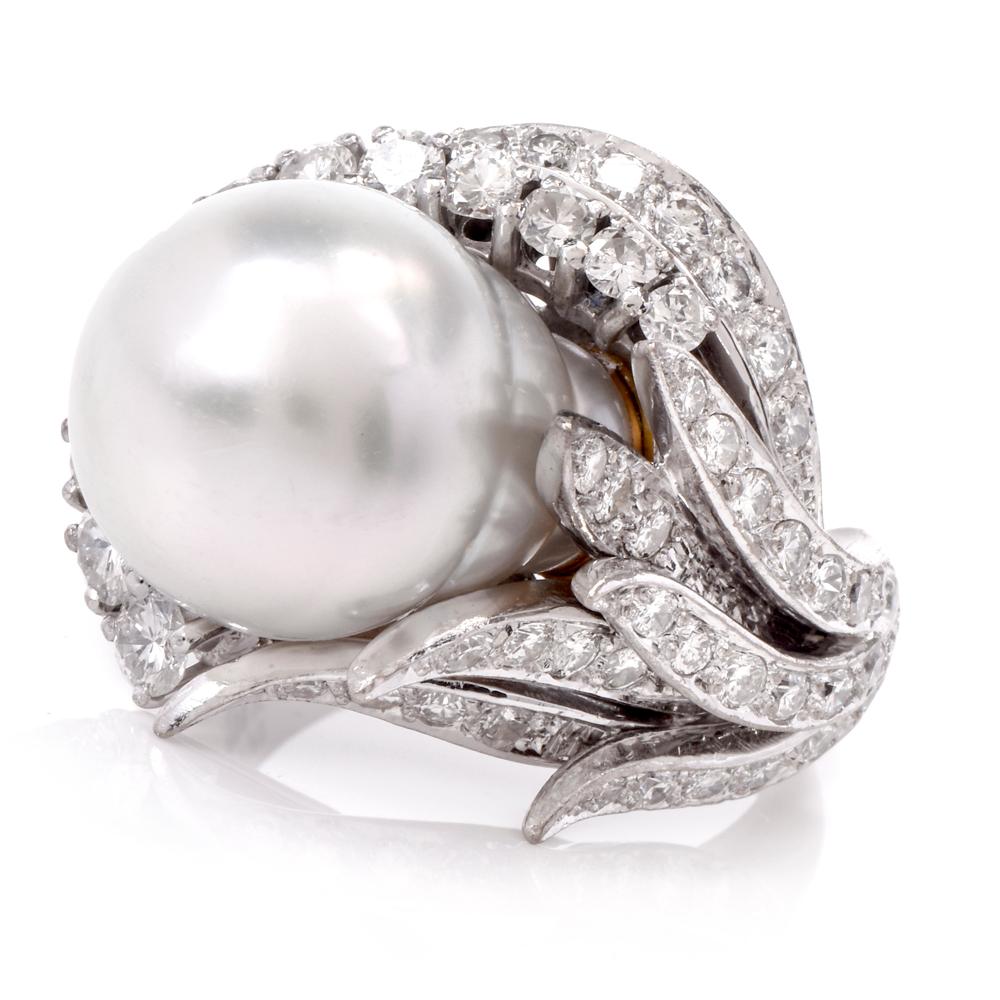 This enchanting cocktail ring crafted in solid 18K white gold exposes an eye-catching silver-gray overtone genuine Baroque Pearl of approximately 13mm. The lustrous organic gem simulates a flower placed within gracefully scrolled diamond-swathed