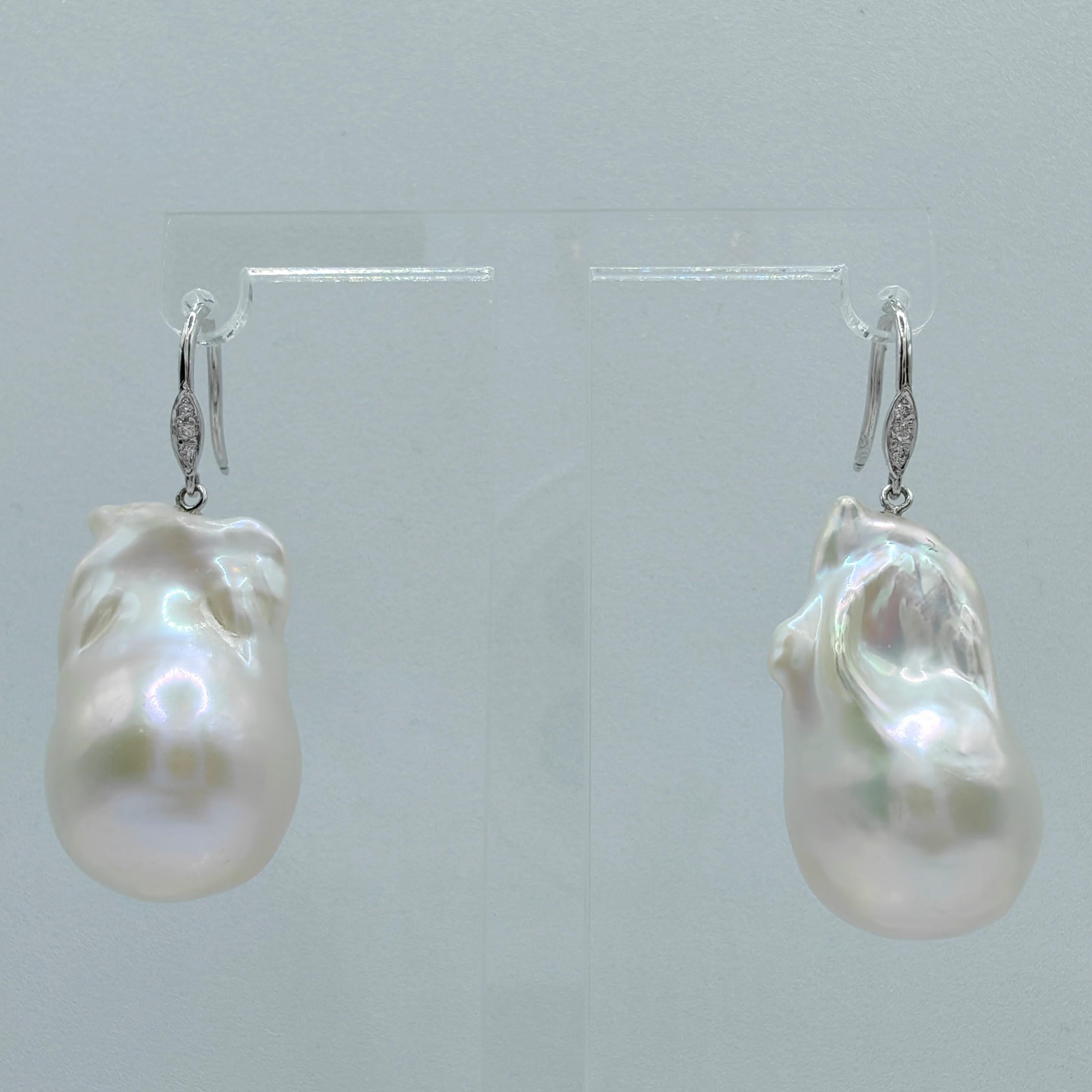 Indulge in the enchanting elegance of our Baroque Pearl Diamond Dangling Drop Earrings with 18K White Gold French Hooks. Featuring two captivating Freshwater Cultured Baroque Pearls, weighing 35.03 and 31.14 carats respectively, these earrings exude