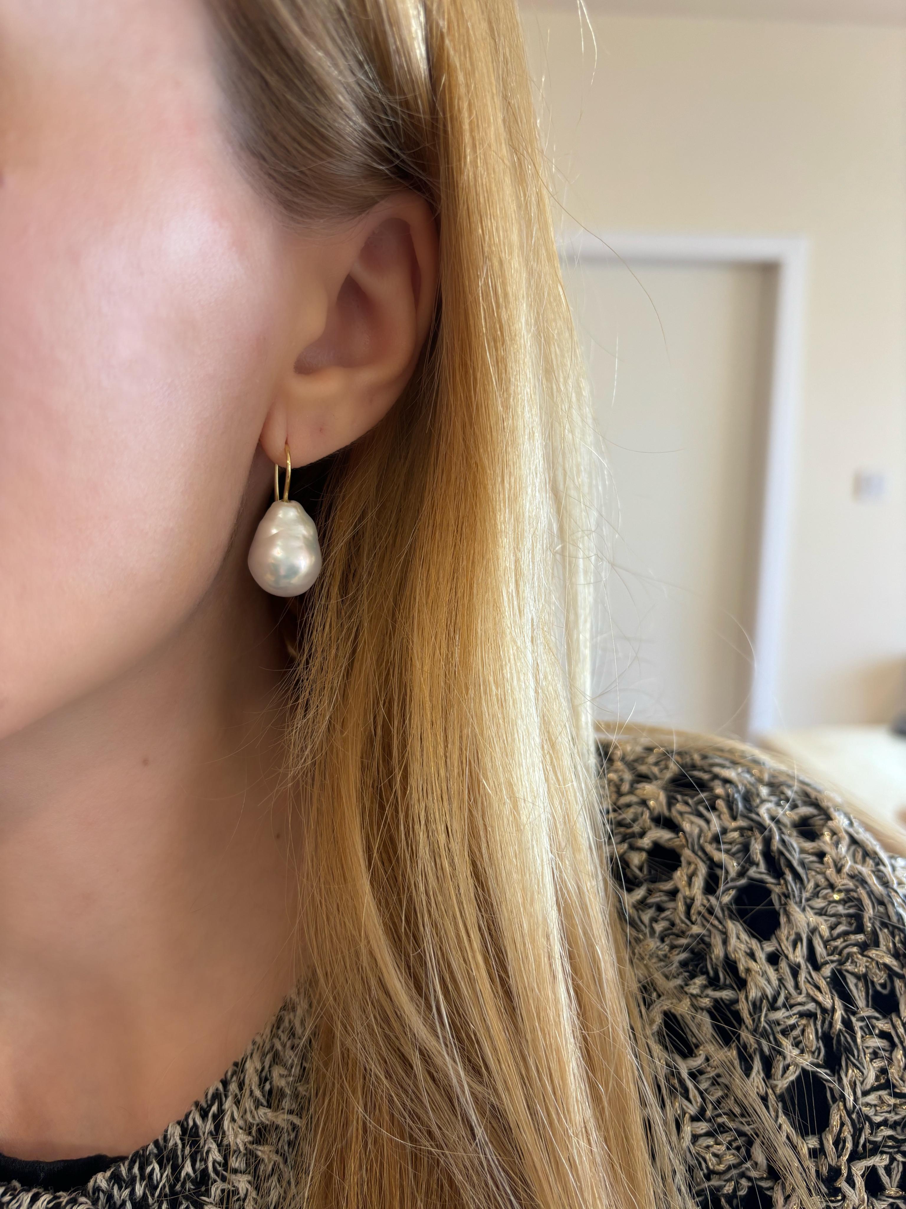 Our Baroque Drop Pearl Earrings by Michelle Massoura are a best seller in our collection. This pair of earrings features baroque, drop shape pearls and a slim 18K Yellow Gold hook design that slips on to the ear. They are easy to slip on and