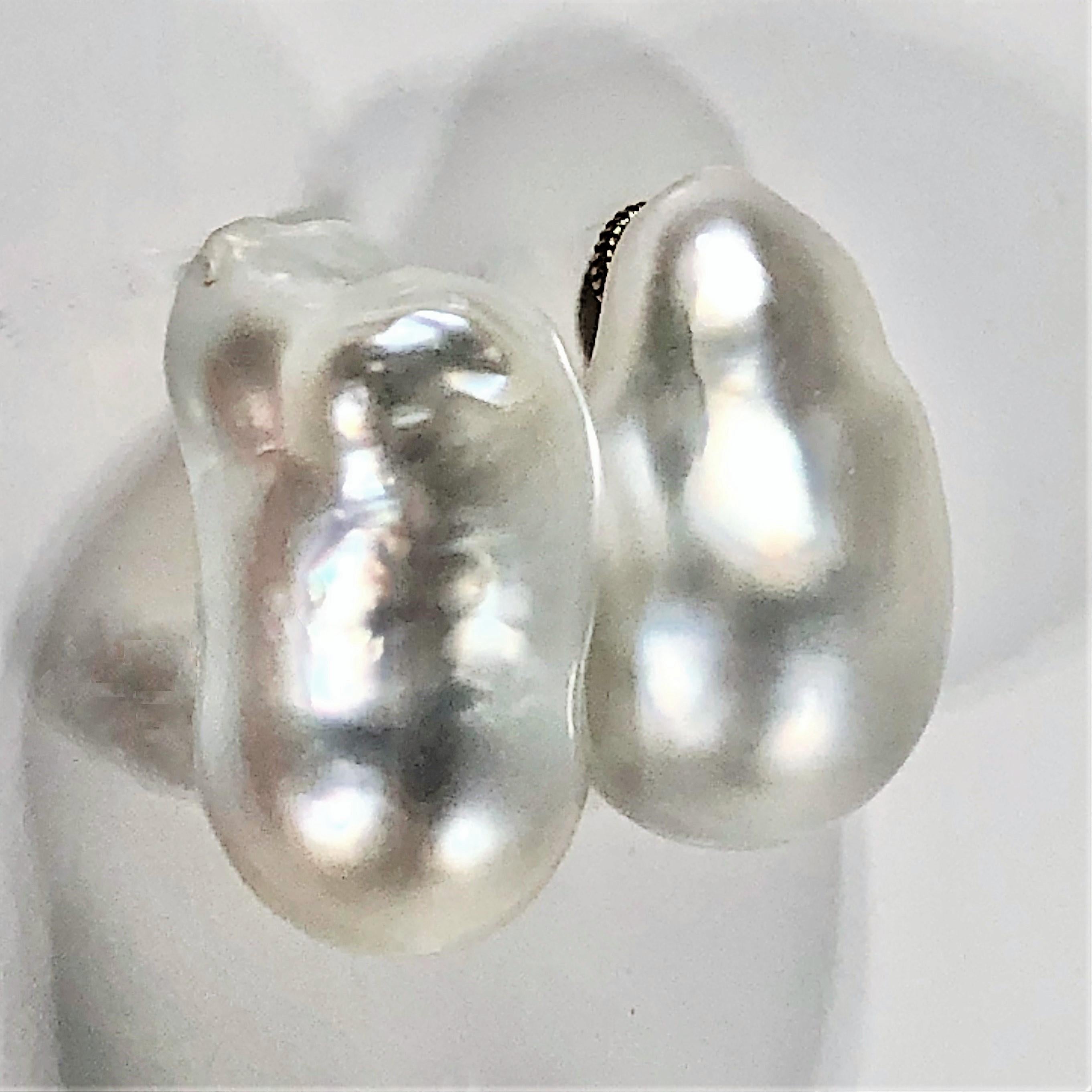 A pair of baroque pearl earrings measuring 27 mm long and 13mm wide, with finely made,
heavy duty 18 karat yellow gold backs. Classic and simple these earrings 
go with everything in your wardrobe, and add a unique flair.