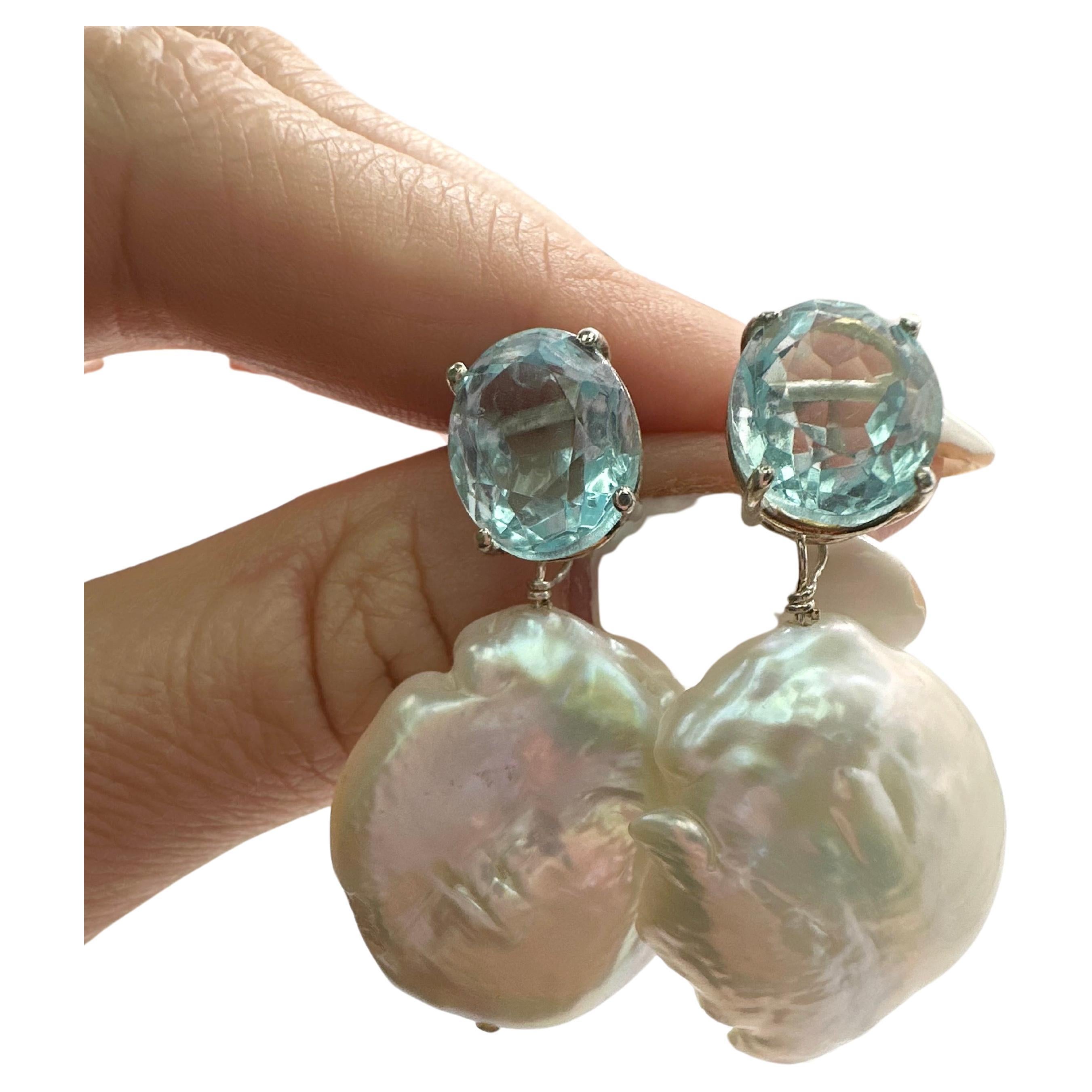 Unique boroque pearl earrings with blue topaz in silver stamped 925, earrings are dangling style!

Certificate of authenticity comes with purchase!

ABOUT US
We are a family-owned business. Our studio in located in the heart of Boca Raton at the