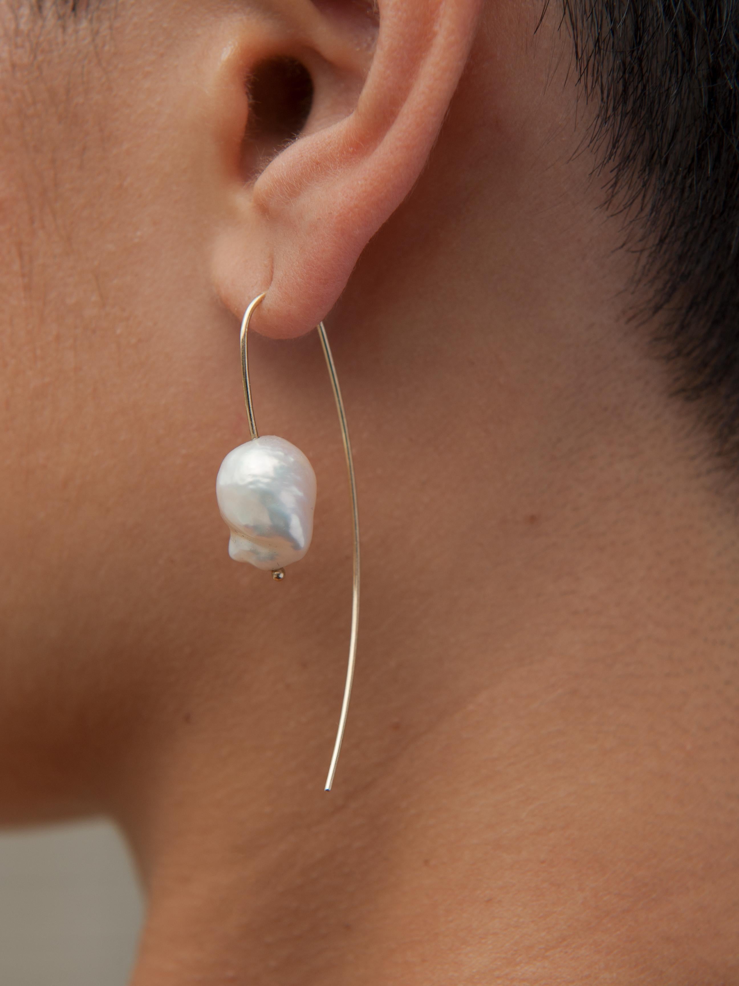 Easily taking you from day through to night, the Nova Baroque Pearl Threaders embody effortless style. Simply thread through the ear, elegantly accenting your look with natural freshwater baroque pearls and recycled 14k gold.  Each pearl will be