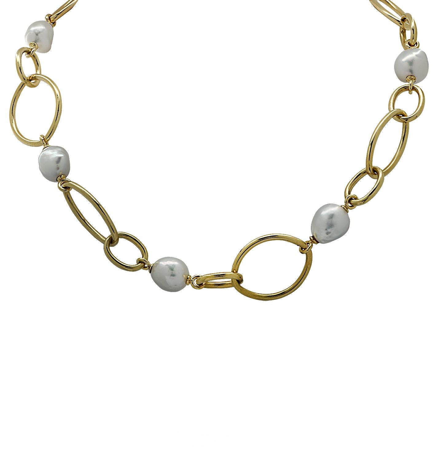 Beautiful necklace crafted in 18 karat yellow gold featuring 7 Baroque Pearls measuring approximately 10-12 mm each, interspersed with yellow gold marquise and oval shaped links. This necklace measures 19 inches in length and .9 of an inch at its