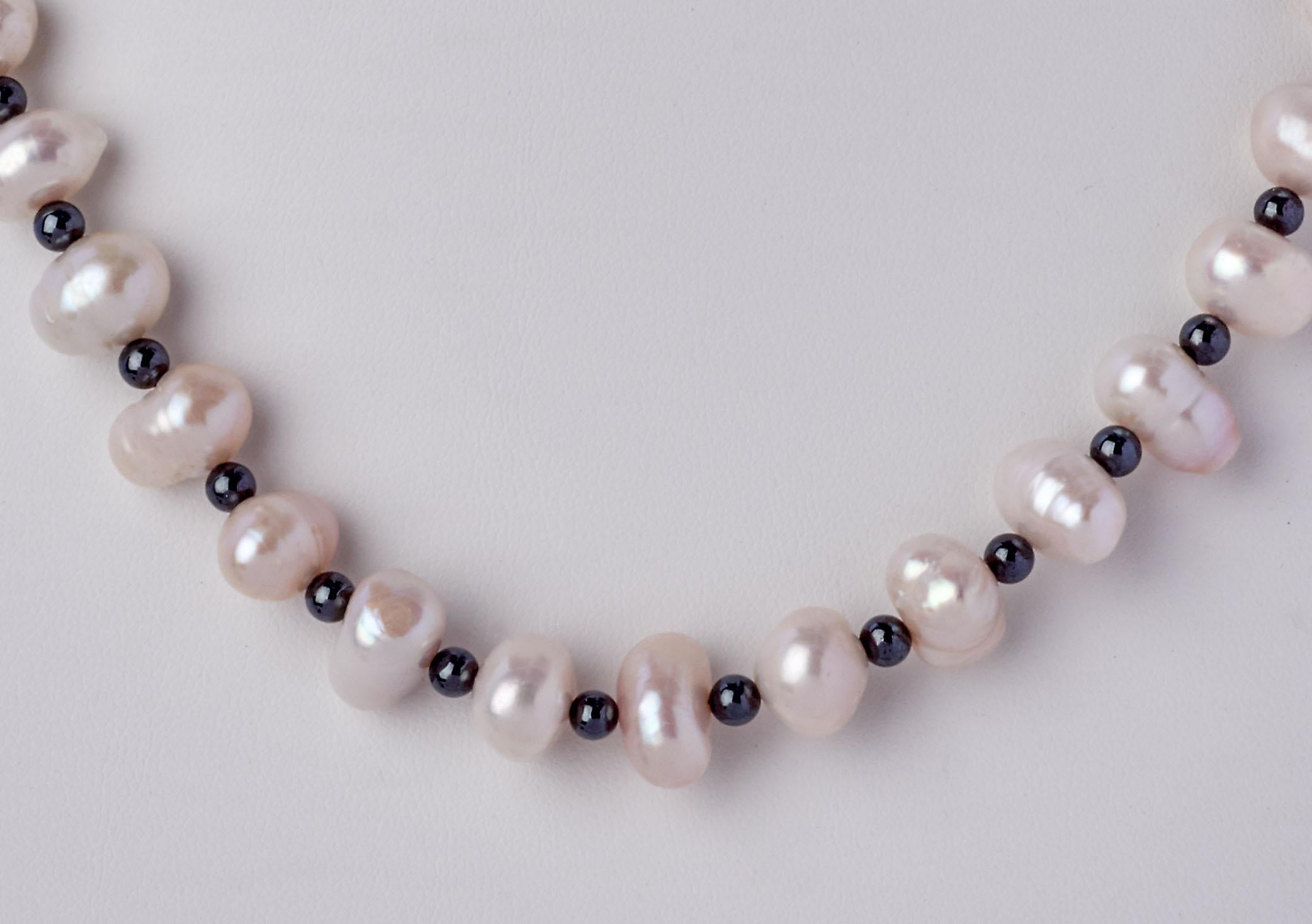 Spectacular, eighteen inch Baroque Akoya Pearl Necklace hand strung with 9 x 11mm Genuine Natural Ringed Akoya White Pearls and accenting reflective 3.5 mm Gray Hematite Beads. This one-of-a-kind Natural Pearl Necklace is finished with a decorative