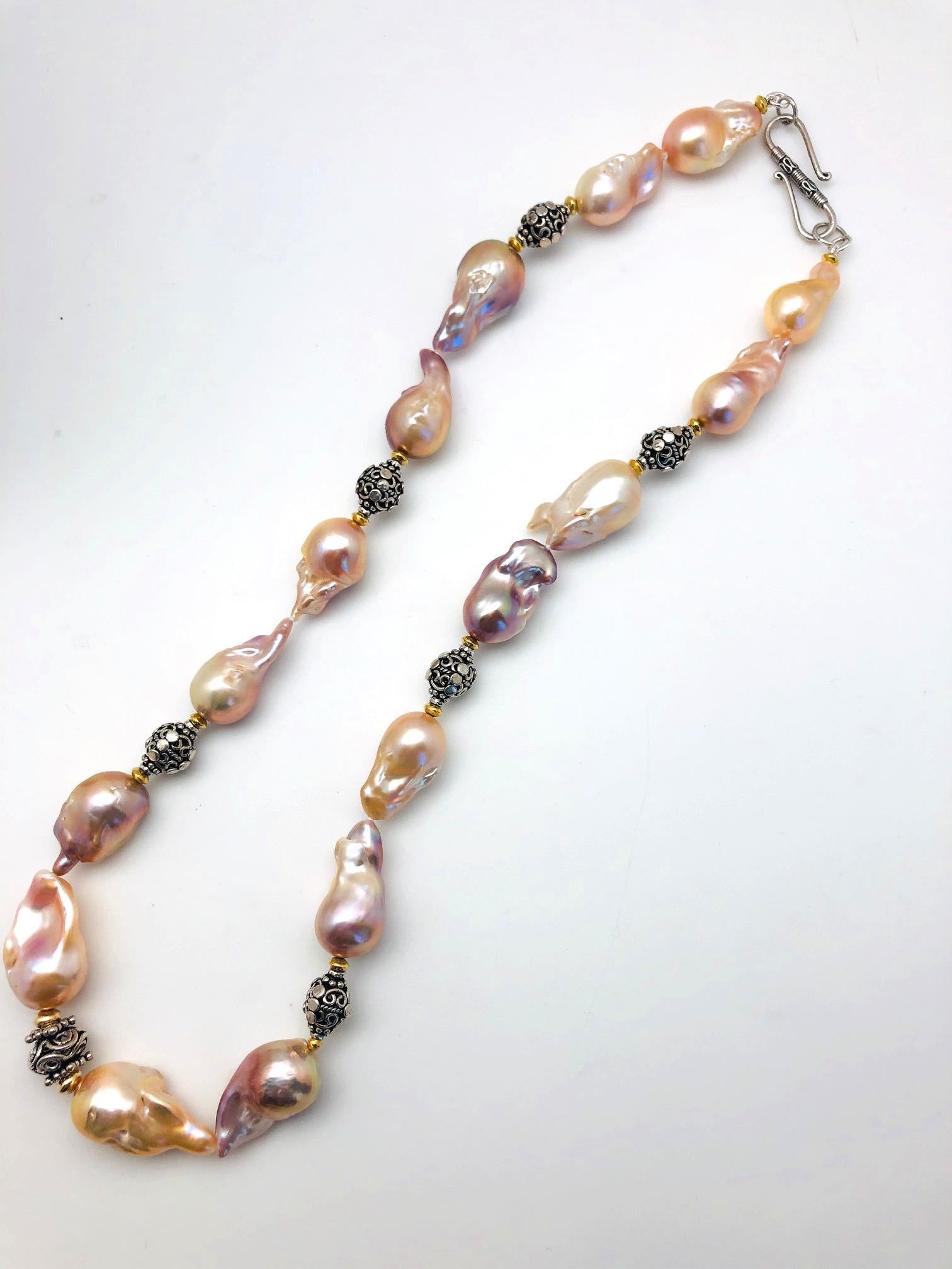 This beautiful strand of pearls is impressive! The large iridescent cream colored pearls have excellent luster and possess gorgeous rose and golden overtones. The individual baroque (freeform) pearls measure approximately 3/4