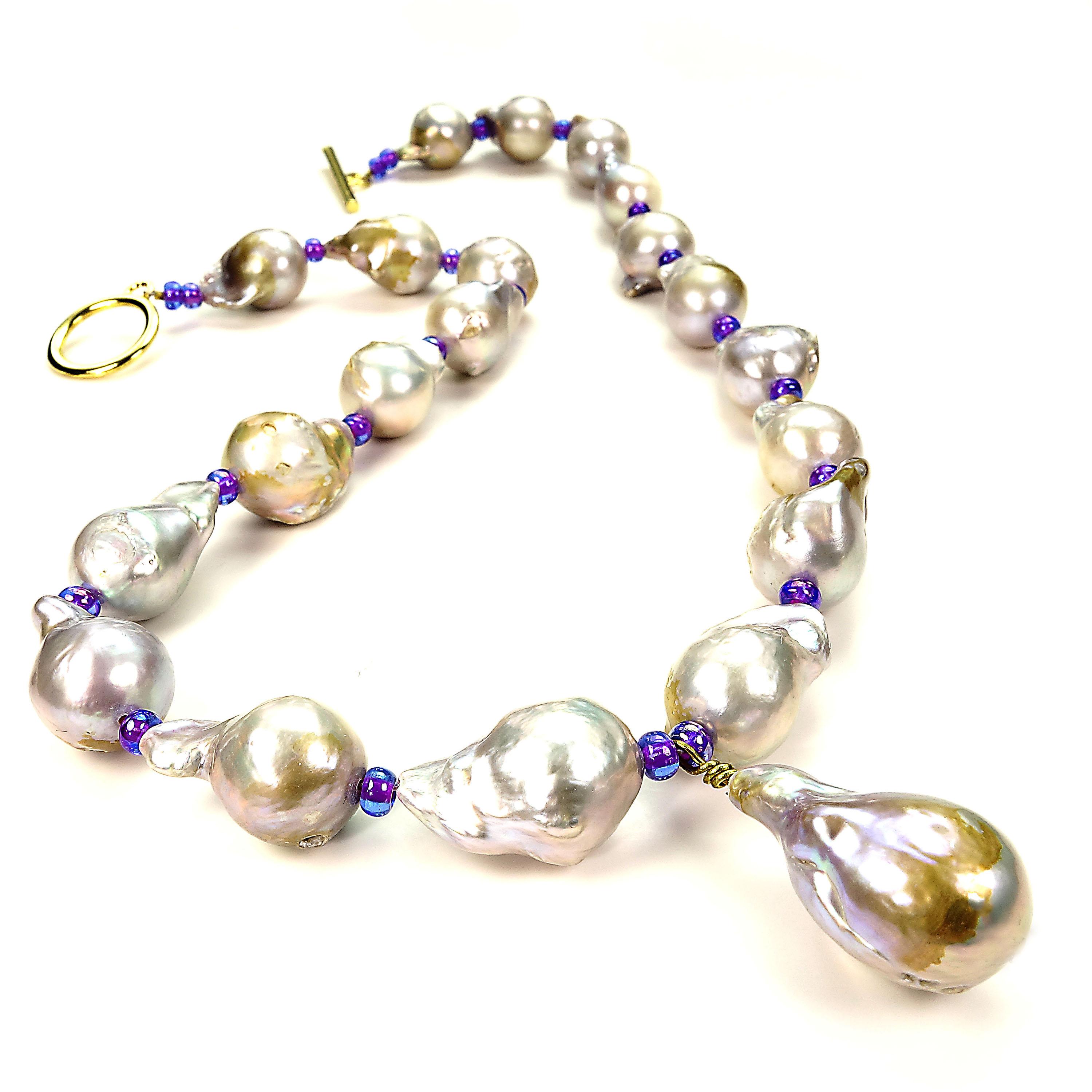 
Custom made, romantic silvery Baroque Pearl Necklace with purple sparkly spacers accenting the iridescent pearls with brown accents. Pearl are approximately 18x13mm, one has pearl seed showing through to surface. Gold tone toggle clasp. 19 inches