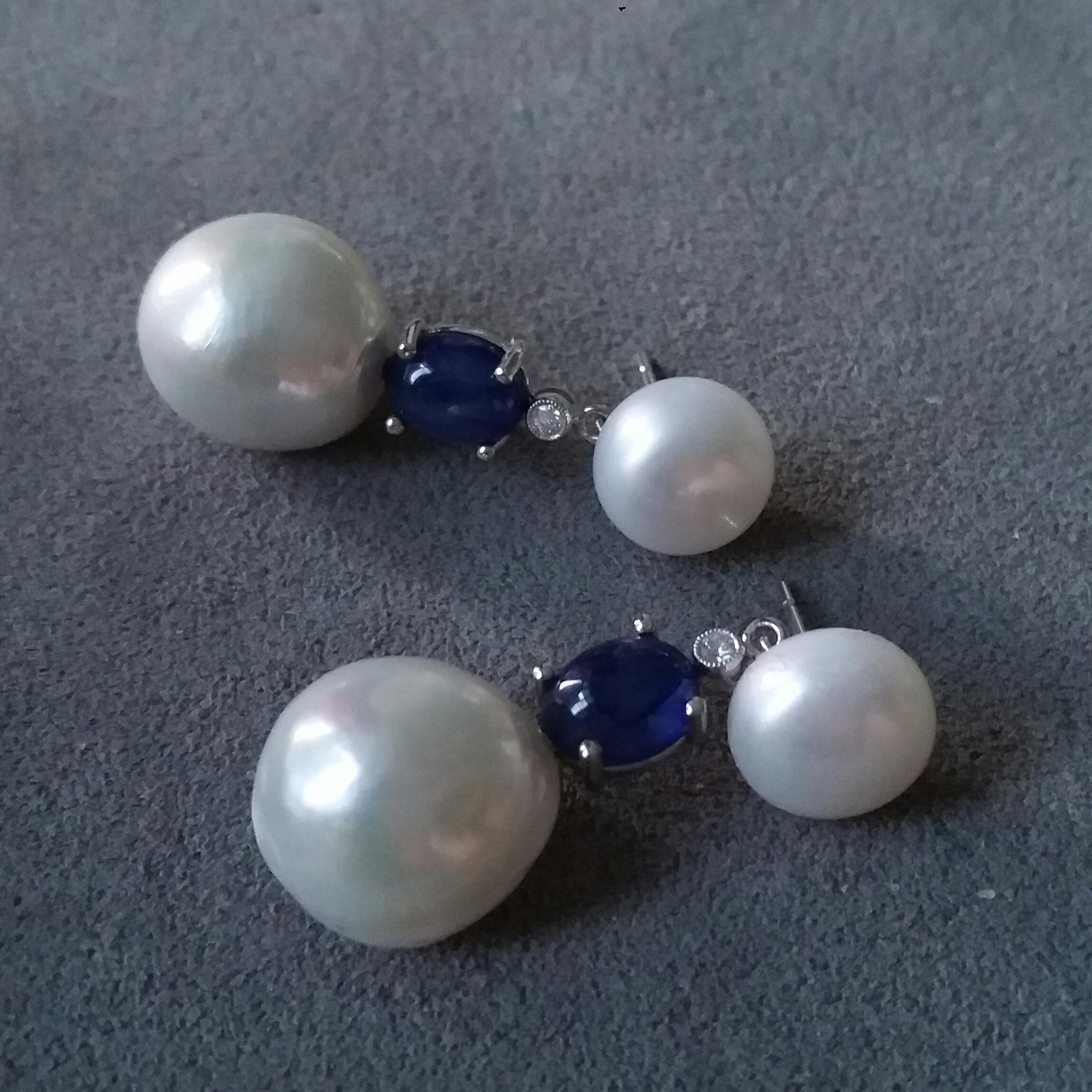 2 button 10 mm in diameter round shape pearls in the top,middle parts with 2 small full cut diamonds and 2 oval blue sapphires cabochons ,lower parts with 2 baroque pearls of about 13 mm in diameter
Dimensions
Top Pearls 10 mm
Bottom Baroque Pearls 